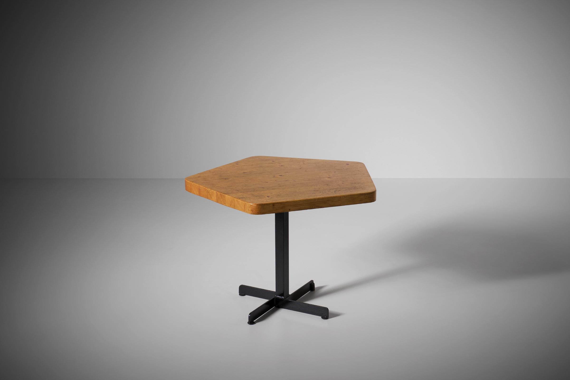 Pentagonal table designed by Charlotte Perriand for the French Ski Resort ‘Les Arcs’, France 1960s. The pentagon shaped top is constructed out of solid Pine slats and shows a nice exposed grain and patina. The top rests on a black lacquered steel