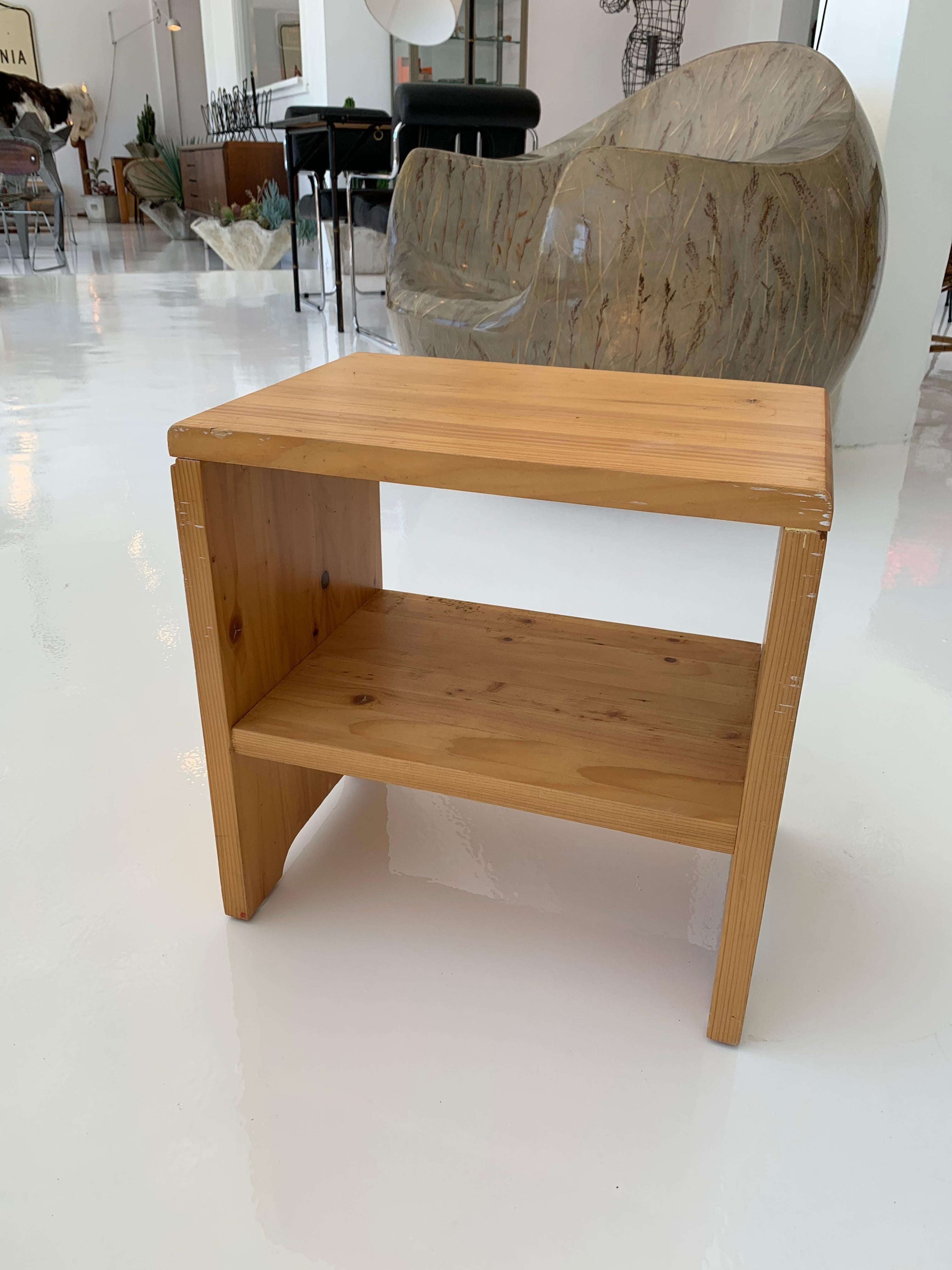 Classic pine side table/stool designed by Charlotte Perriand for the Les Arcs Ski Resort in France. Great lines. Good vintage condition. Super functional with inset shelf to be used as a side table. Extremely sturdy and able to be used as a stool as