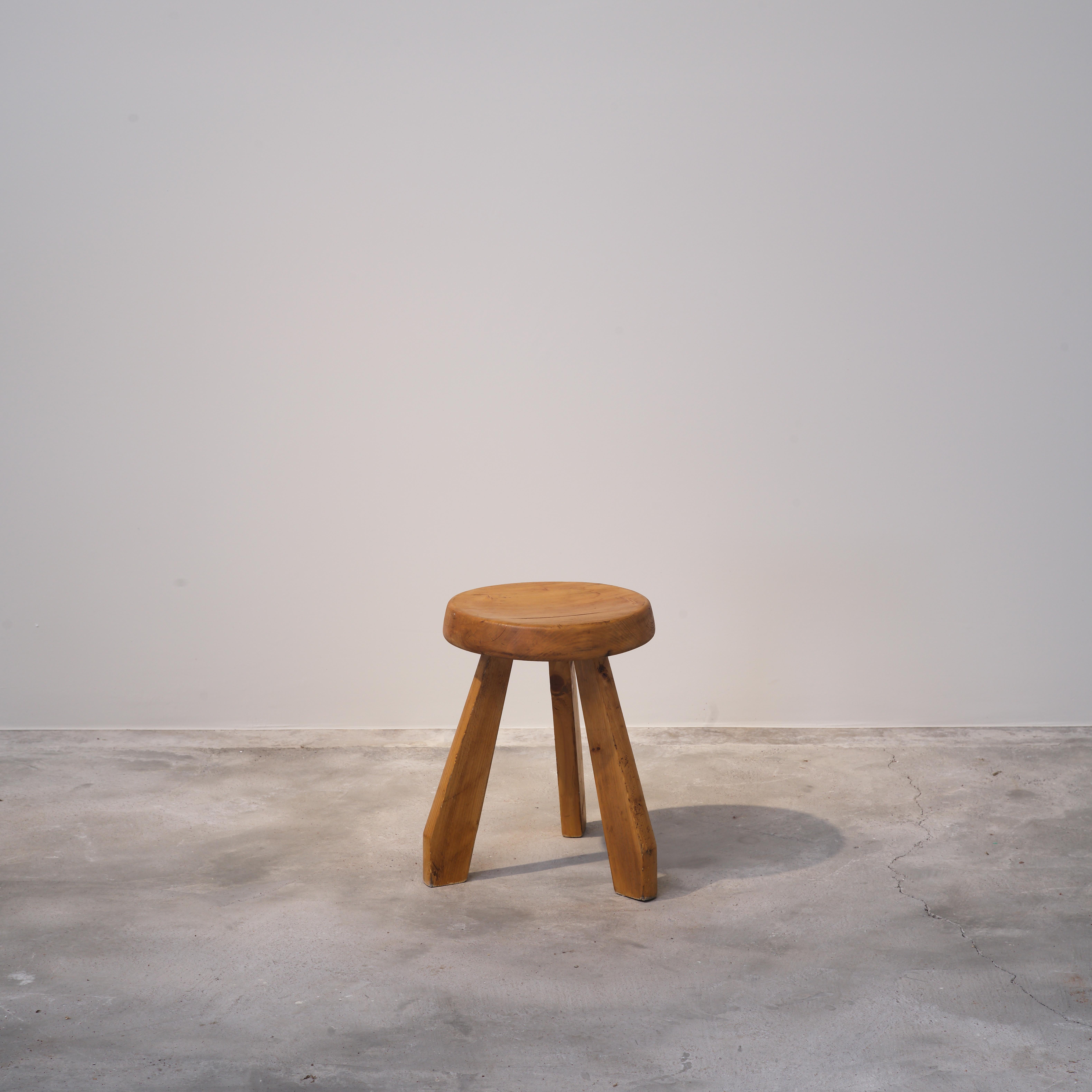 This pine stool by Charlotte Perriand, known as the Sandoz stool, was first created in 1955 and later used in her own chalet in Méribel. The design is reduced and solid — a thick, rounded seat resting on three sturdy legs. By 1962, the same model