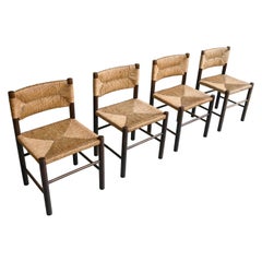 Charlotte Perriand:: Ensemble de quatre chaises "Dordogne" en bois et canne:: France:: années 1960