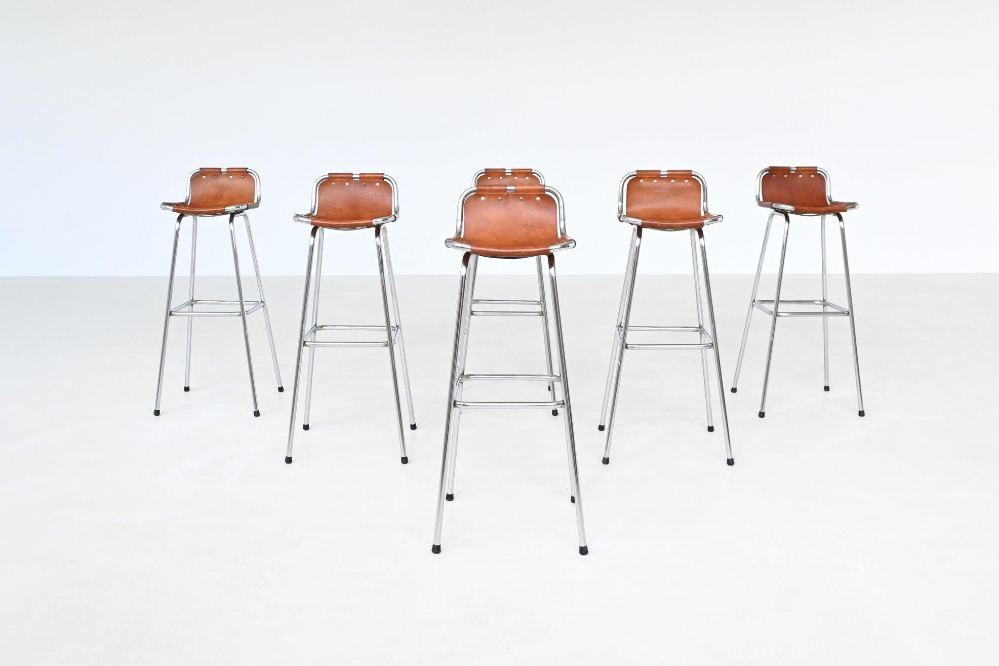 Beautifully shaped set of six bar stools used by Charlotte Perriand for the Les Arcs ski resort in France, 1960. These iconic stools embody a refined balance between rustic charm and industrial elegance, and are among the most sought-after bar