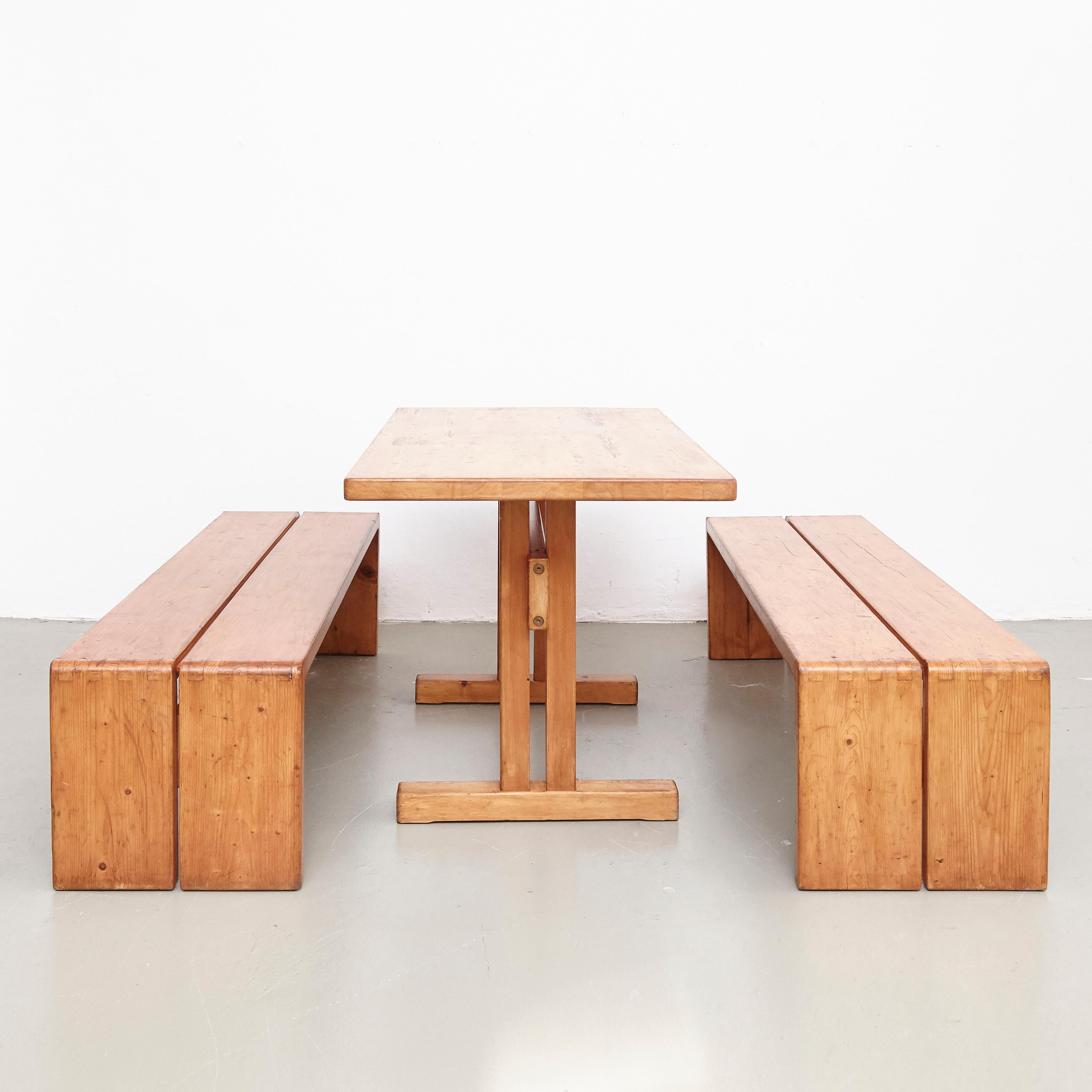 Set of table and two benches designed by Charlotte Perriand for Les Arcs ski resort, circa 1960, manufactured in France.

Pinewood.

In original condition, with minor wear consistent with age and use, preserving a beautiful patina.

Table: 120