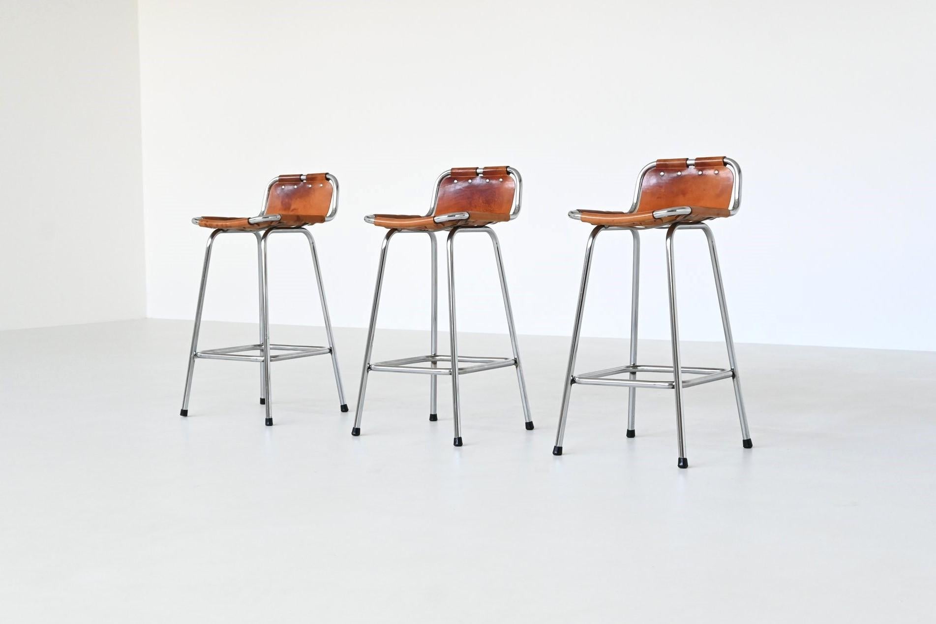 Beautiful shaped set of three bar stools used by Charlotte Perriand for Les Arcs ski resort, France 1960. These iconic stools feature an elegant combination of rustic charm and industrial strength. The seats are crafted from very nice patinated