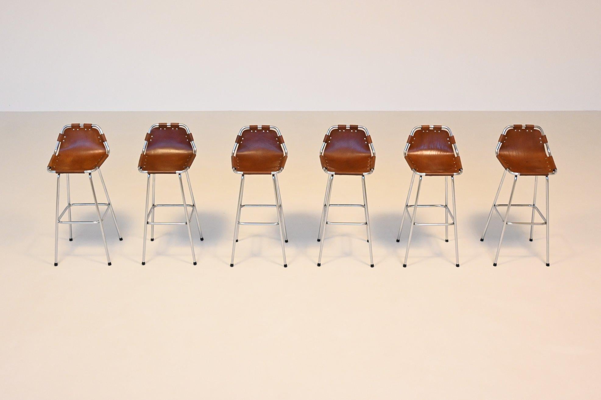 Beautiful shaped set of three beautiful shaped bar stools used by Charlotte Perriand for Les Arcs ski resort, France 1960. These iconic stools feature an elegant combination of rustic charm and industrial strength. The seats are crafted from
