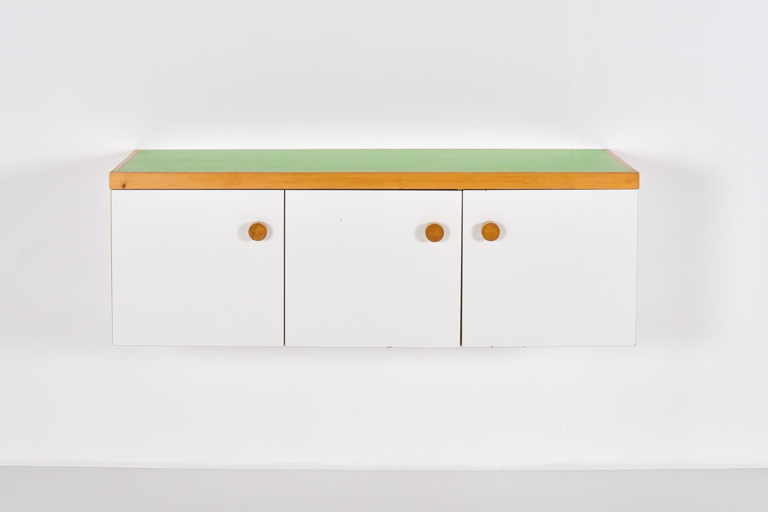Charlotte Perriand; Side board; les arcs; 3 doors; modernism; 

Beautiful three doors sideboard in thick pine wood and white plastic laminate on the doors and sides, green laminate on the top. Nice large wooden knobs. Designed by Charlotte