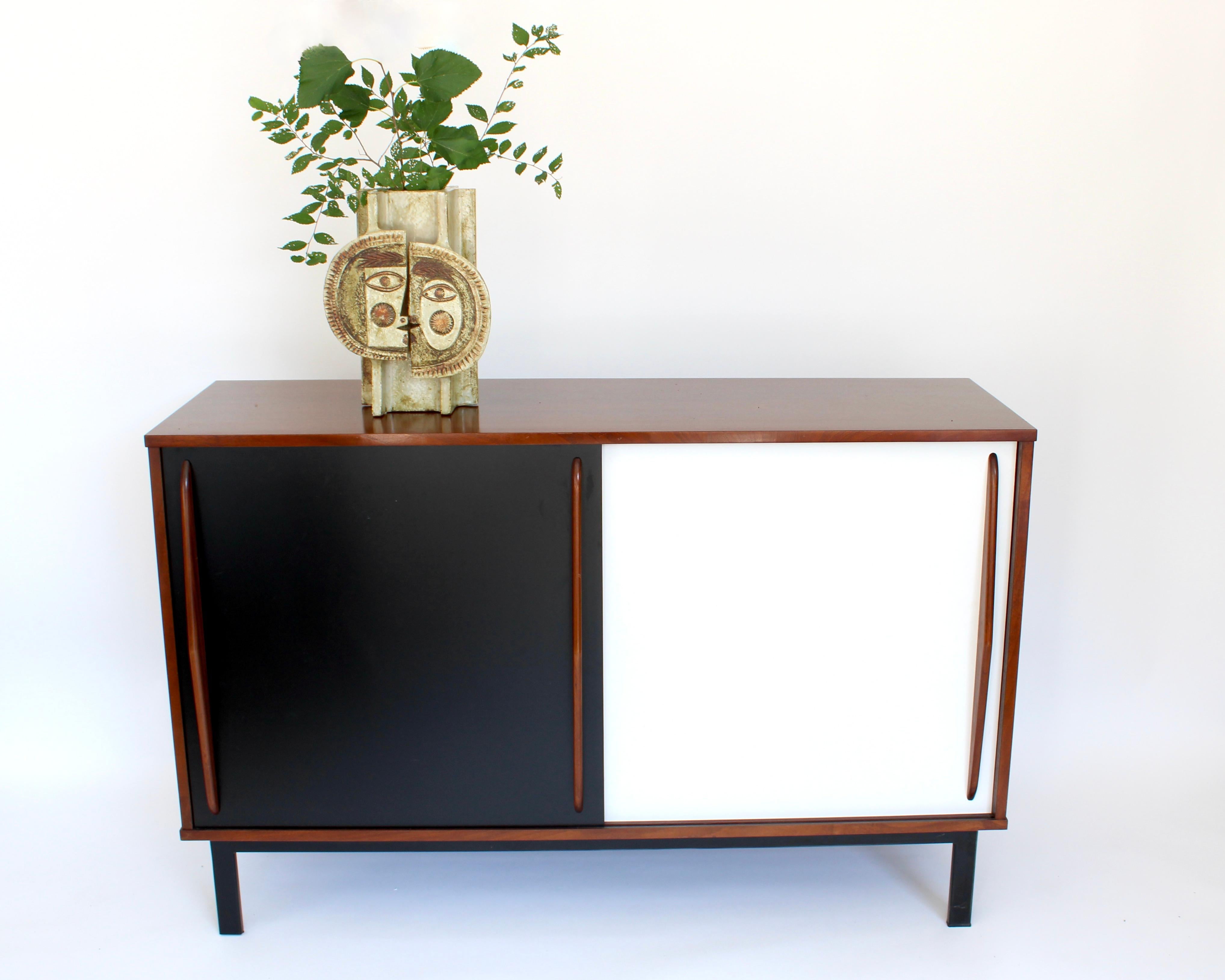 This Cansado, small sliding door sideboard was designed by Charlotte Perriand circa 1950 for the residents of the mining town of Cansado of the same name in Mauritania. It was manufactured in France during her association with Step Simon gallery. It