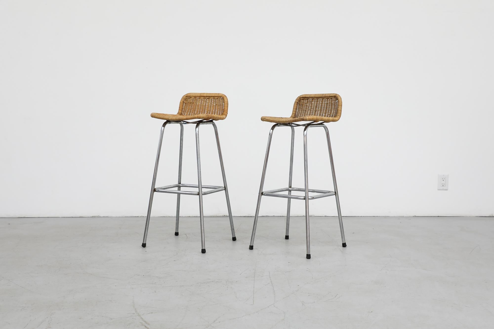 Charlotte Perriand style bar stools by Dirk van Sliedregt for Rohe Noordwolde with low rounded rattan seat backs and chrome tubular frames. Seat height is 30