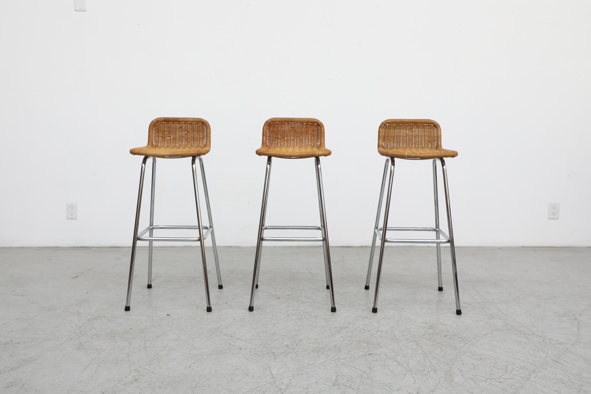 Charlotte Perriand style rattan bar stools by Dutch designer Dirk van Sliedregt for Rohe Noordwolde with low, rounded seat backs and chrome tubular frames. Seat height is 30
