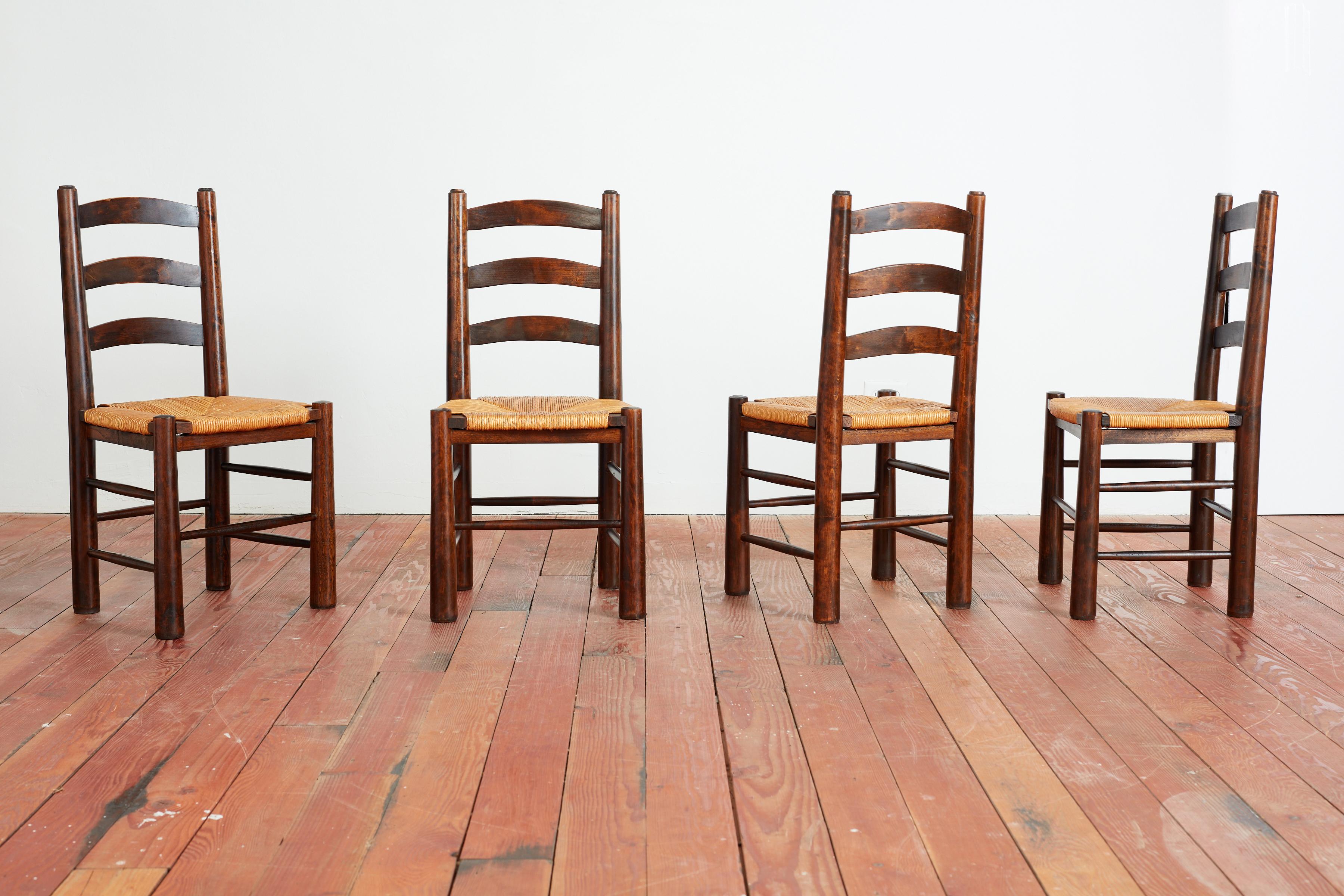 Dining room chairs in the style of Charlotte Perriand with ladder backs and woven straw seats.
Nice dark wood stain with wonderful patina
Priced as a set of 4 