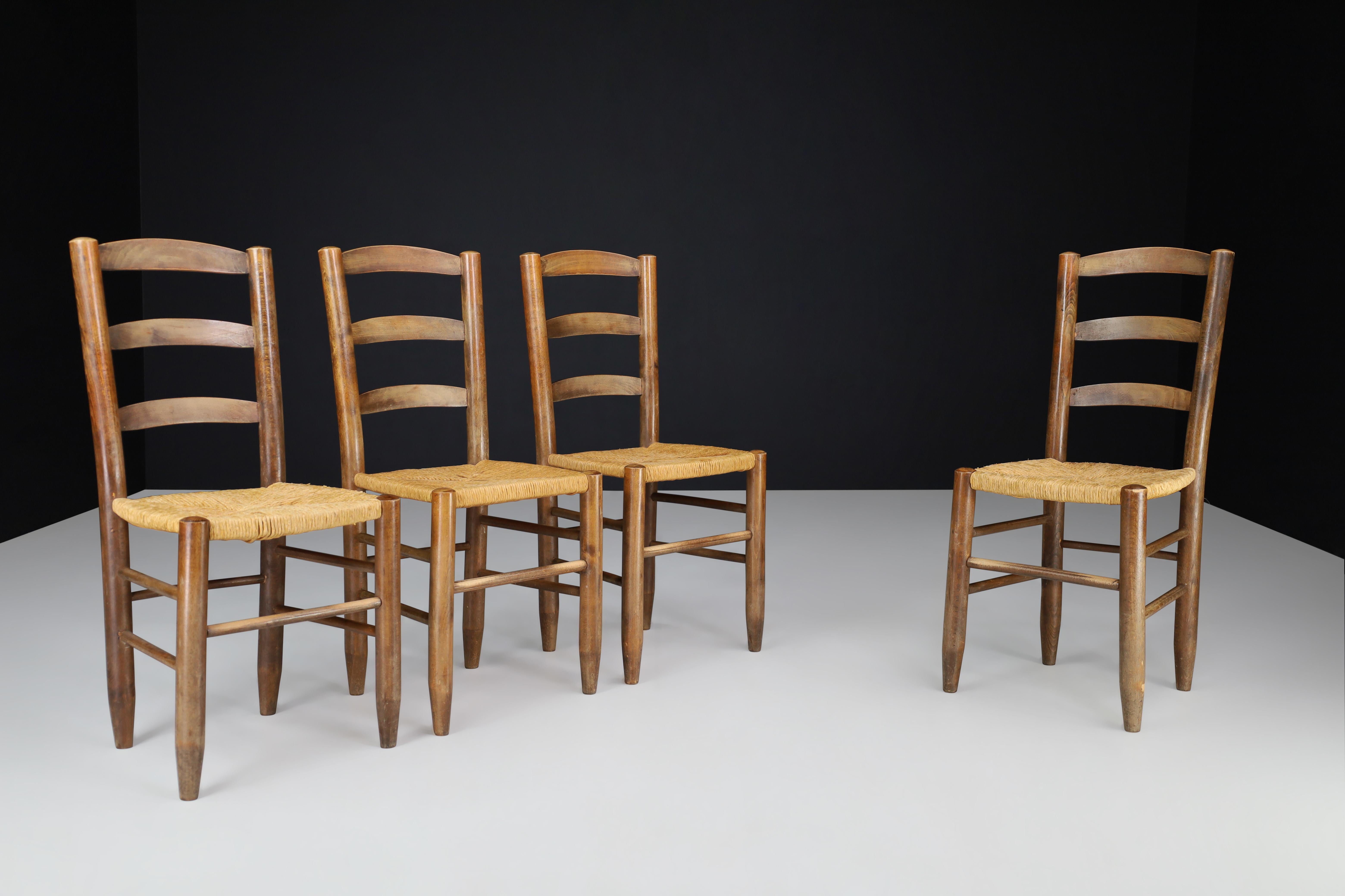 Charlotte Perriand Style Dining Chairs, France, 1950s.

These dining chairs in the style of Charlotte Perriand were made in France during the 1950s. They are crafted from solid beech and rush and possess a beautiful natural patina while being in