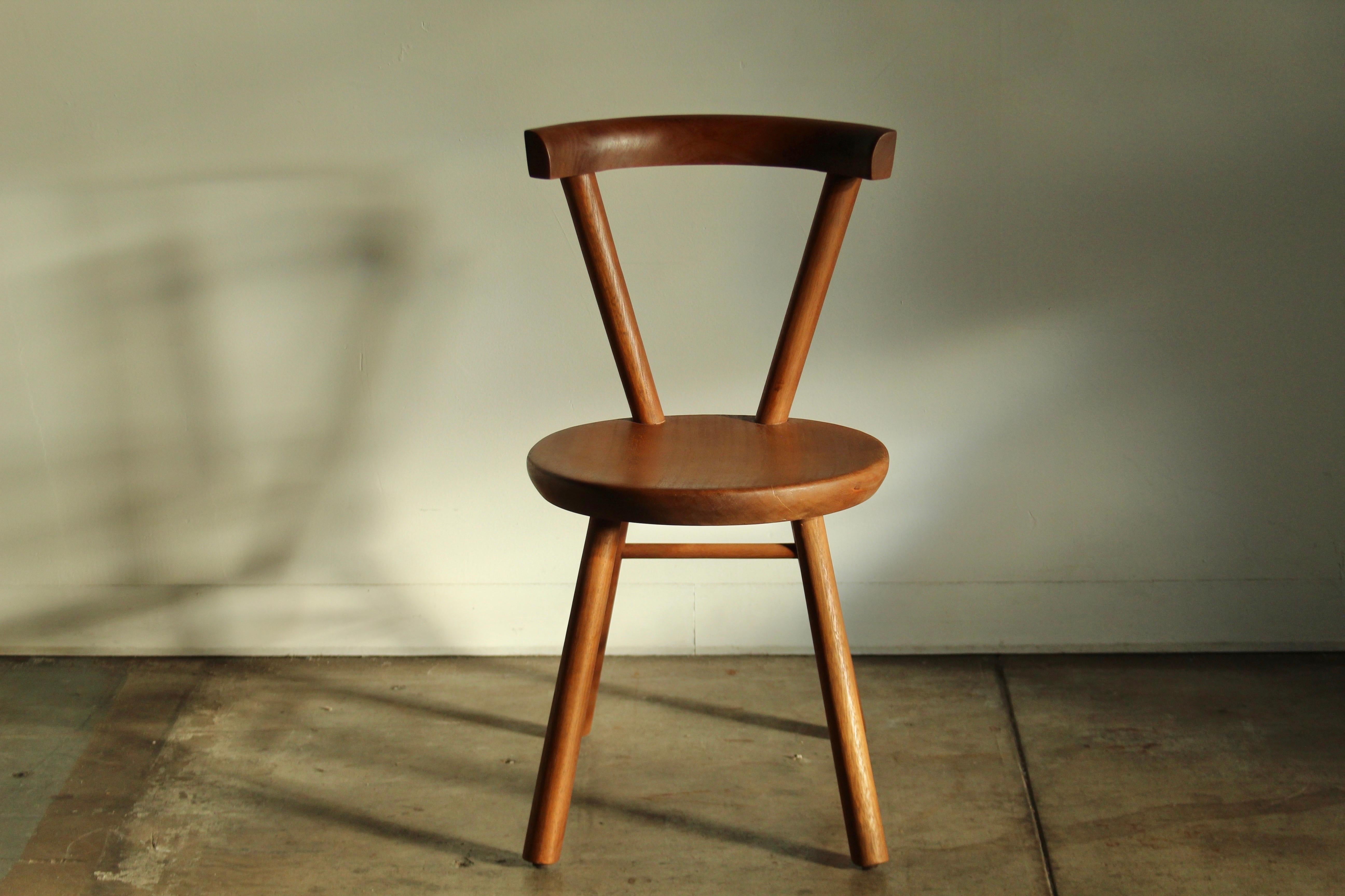 Beautiful modernist dining or accent chair constructed in solid mahogany circa 1980s, in the style of the Charlotte Perriand or Jean Touret. Superb craftsmanship, without any screws or hardware. Tons of character. Perfect at a dining table, a desk,
