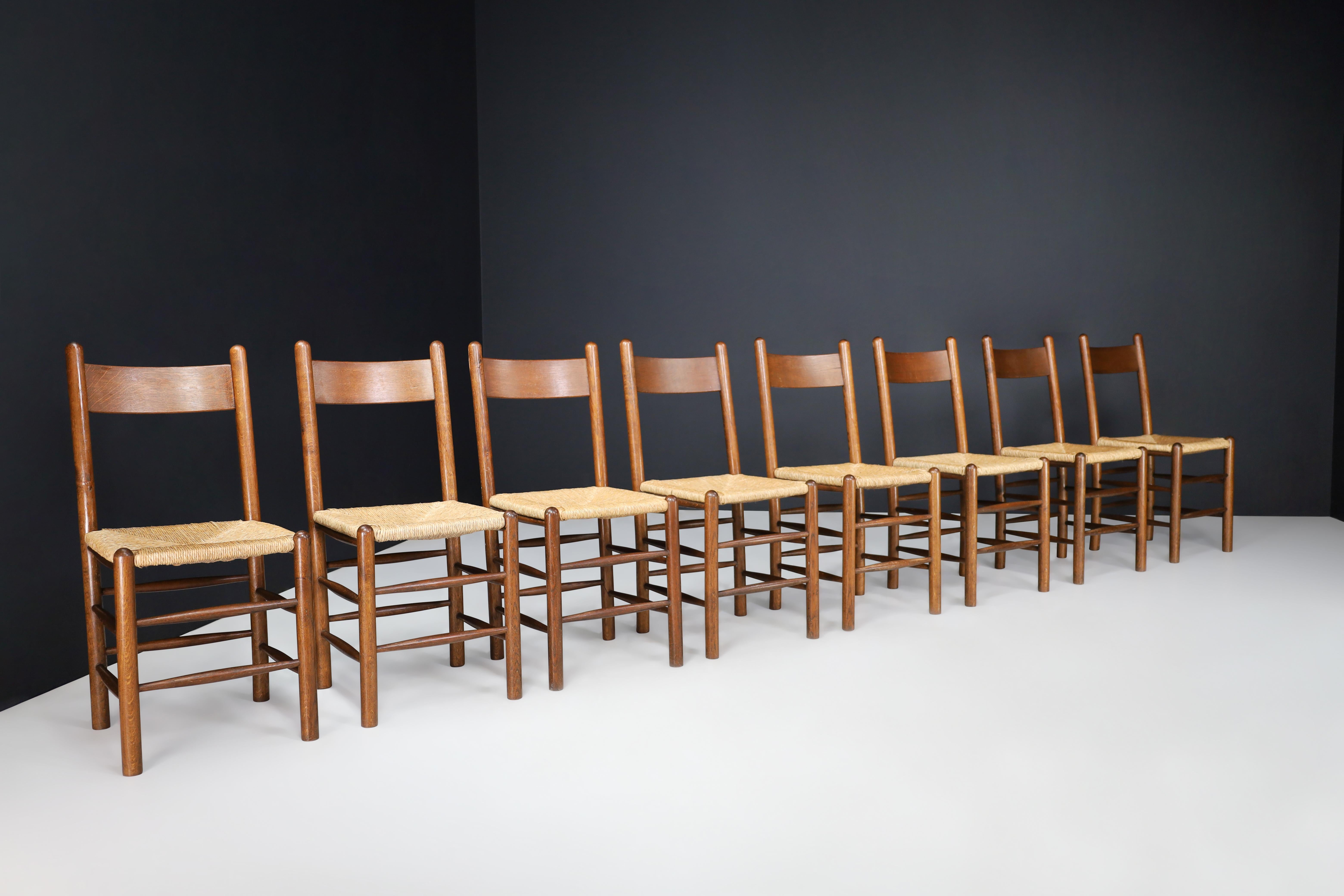 Charlotte Perriand Style Oak and Rush Dining Room Chairs, France, 1960s 

These 30 dining room chairs in the style of Charlotte Perriand are from France in the 1960s. Made from solid French oak and rush, they showcase a natural patina and are in