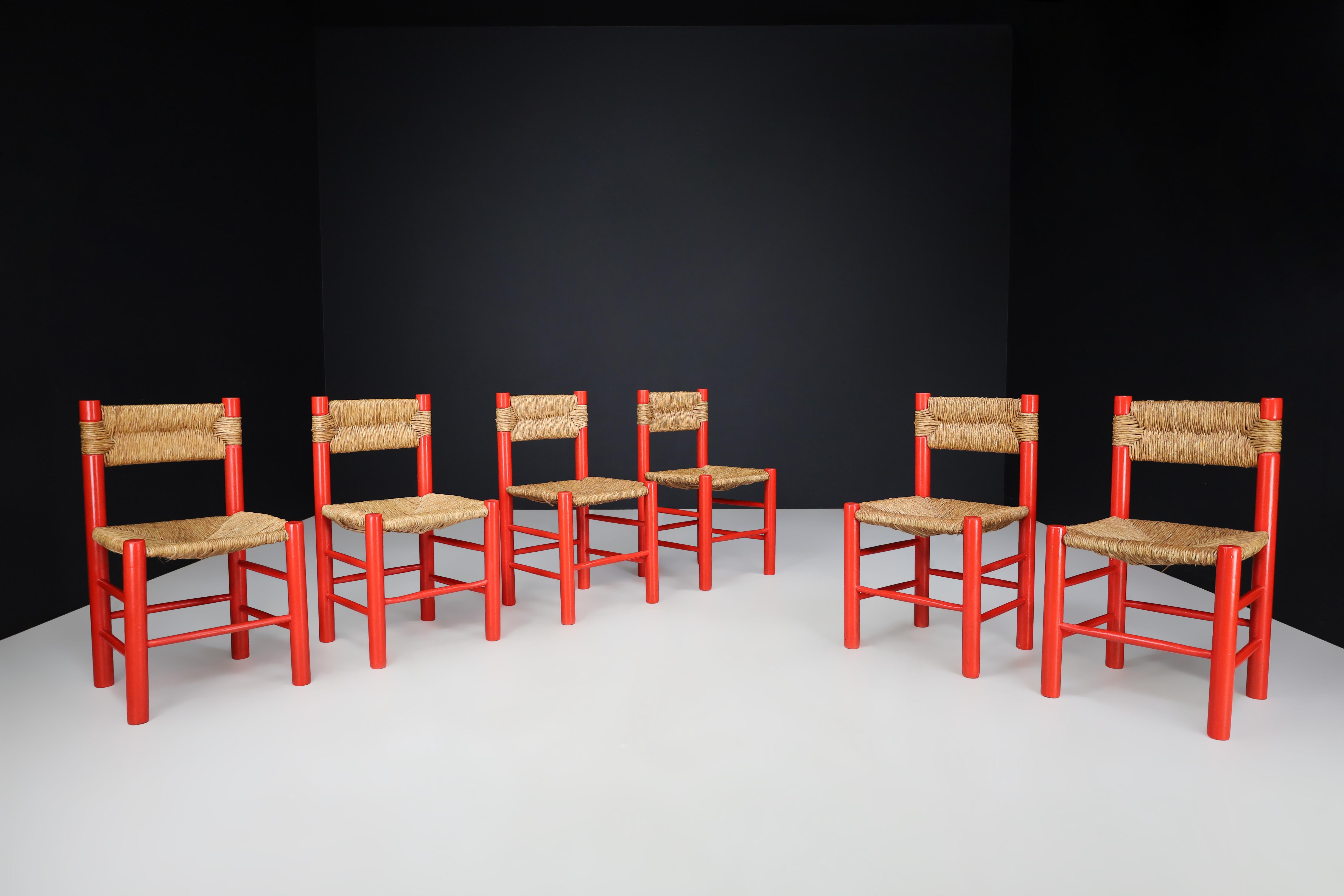 Charlotte Perriand Style Red Painted Beech and Rush Dining Room Chairs, France 1960s 

This large set of 6 red painted dining room chairs are crafted in the style of Charlotte Perriand and were made in France in the 1960s. They are composed of solid