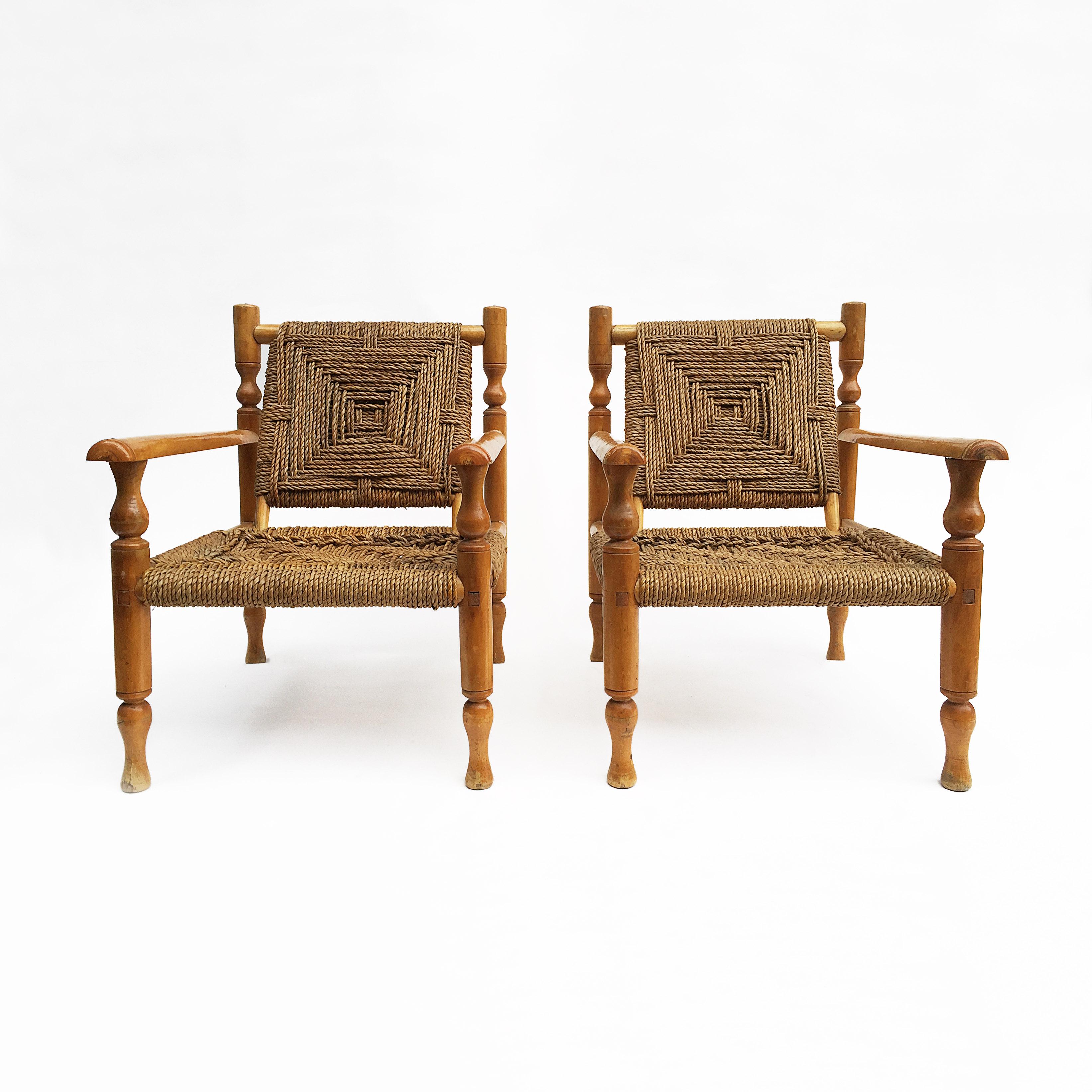 Highly desired pair of Charlotte Perriand style woven lounge armchairs beautifully crafted and structured. The frame of the chairs are build out of ashwood and comes with a woven sisal rope seat and backrest. Overall good condition but would benefit