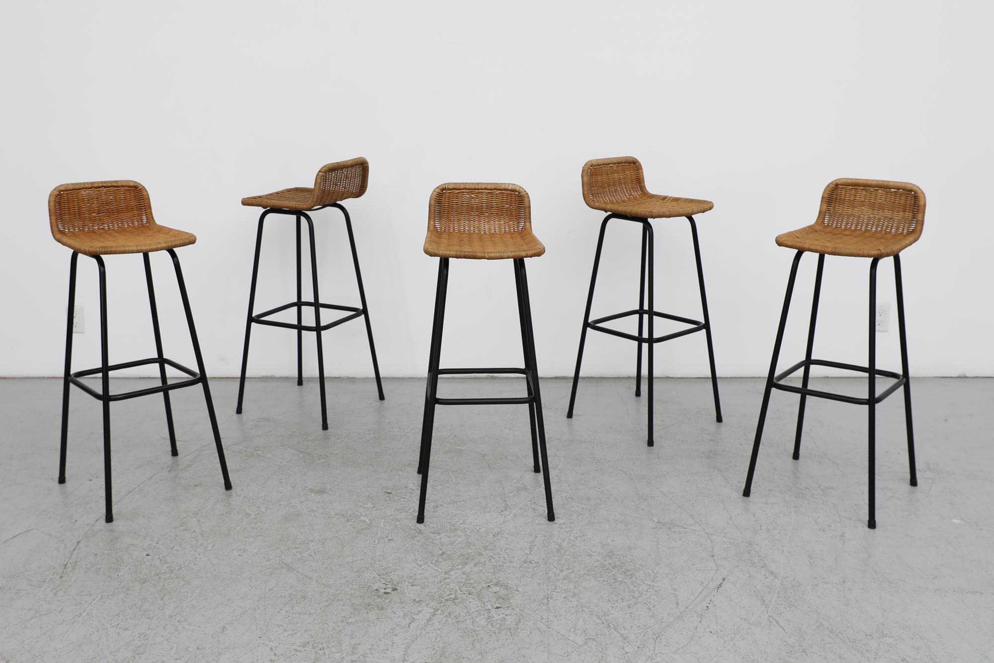 Mid-Century, Charlotte Perriand style wicker bar stools with black enameled legs as designed by Dutch post war designer Dirk van Sliedregt for Rohe Noordwolde, a furniture maker that was widely renowned for their use of wicker, rattan bamboo in