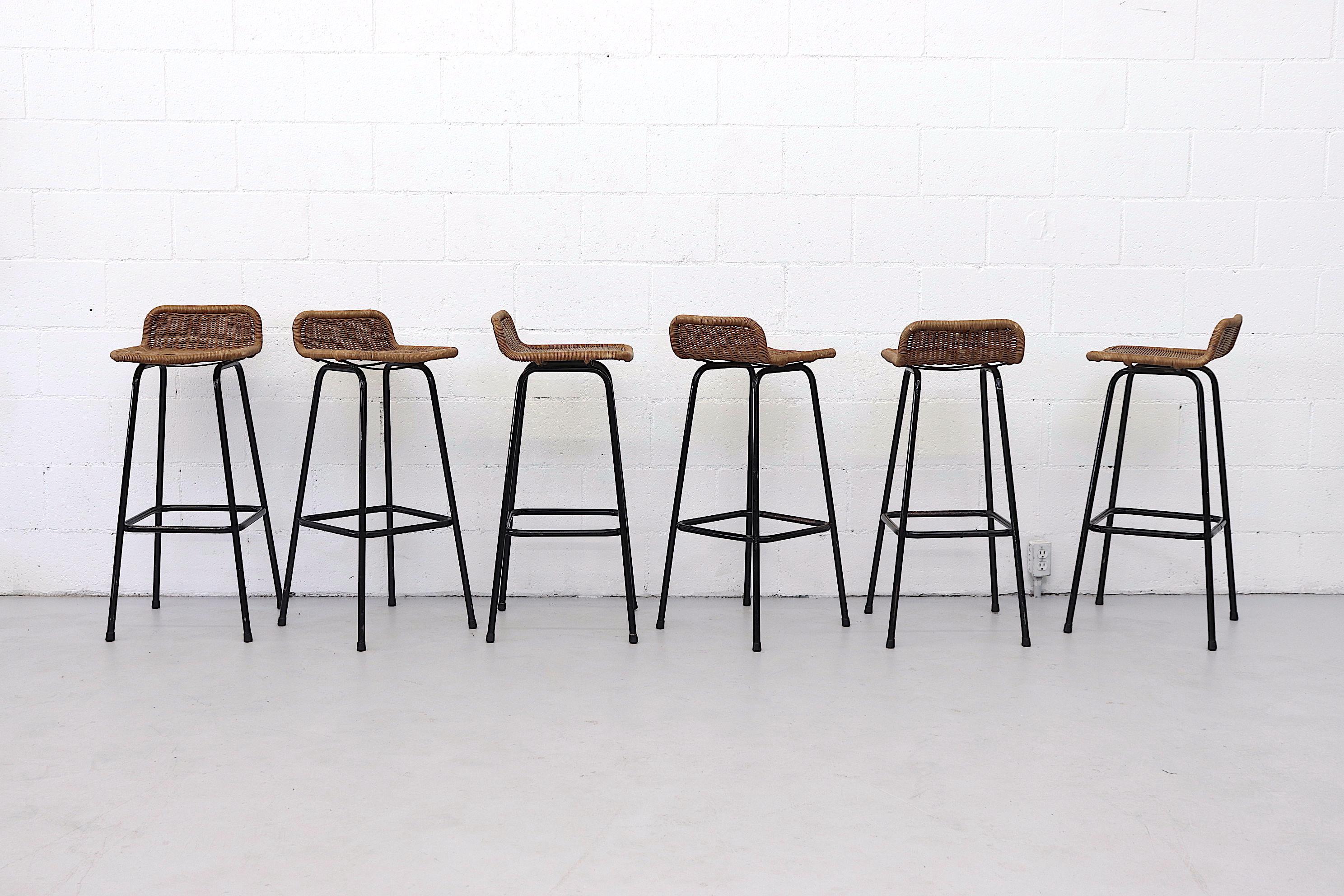 Charlotte Perriand style low back bar stools with rounded wicker back with enameled black tubular frame. 31.5