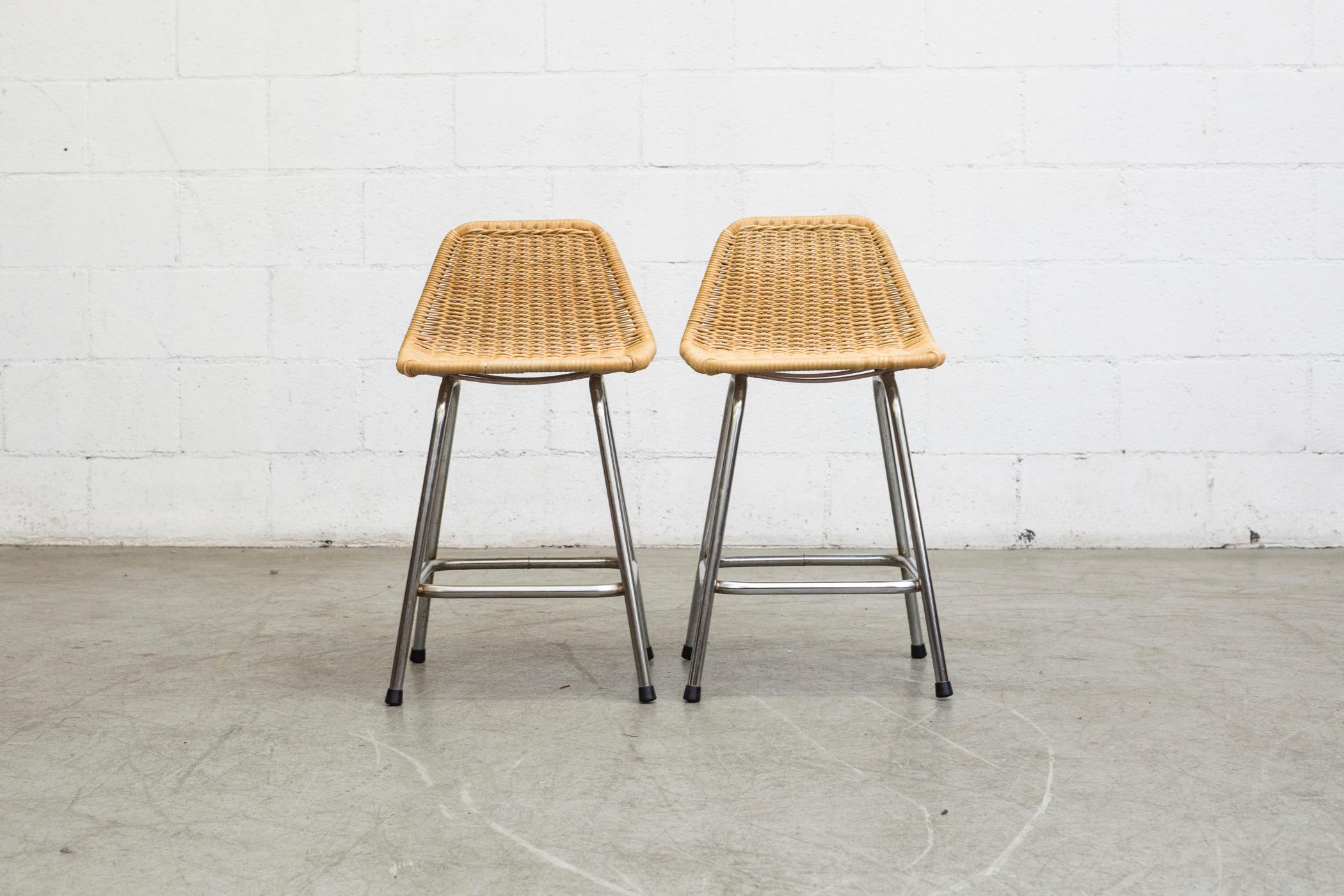 Charlotte Perriand inspired Wicker and chrome metal Counter stools with angled seat back by Dirk van Sliedregt for Rohe Noordwolde. The stools are slightly different in size and patina. In original condition with visible wear consistent with age and
