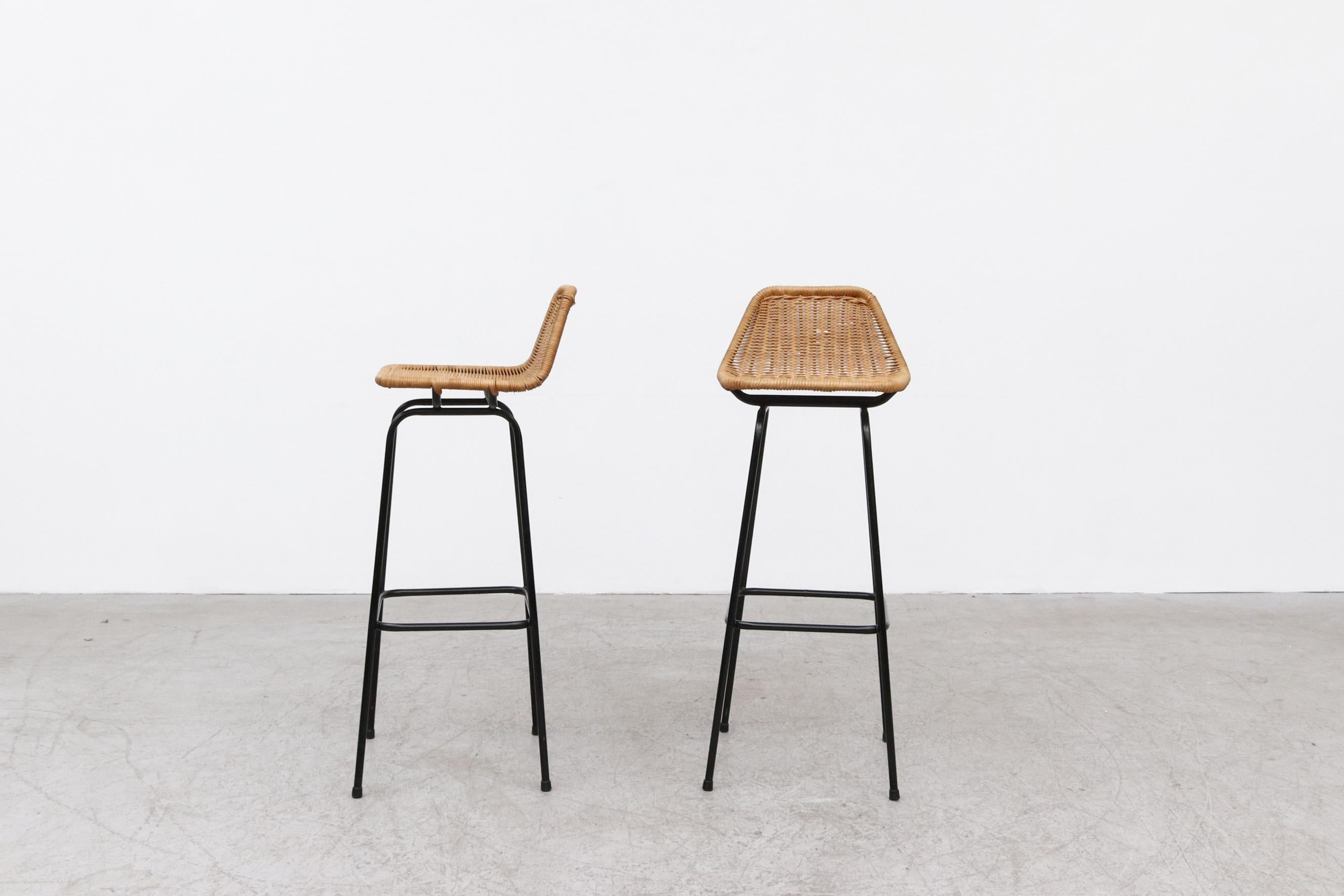 Charlotte Perriand Style Wicker bar stools with angled seat back and black legs. Seat height is 33
