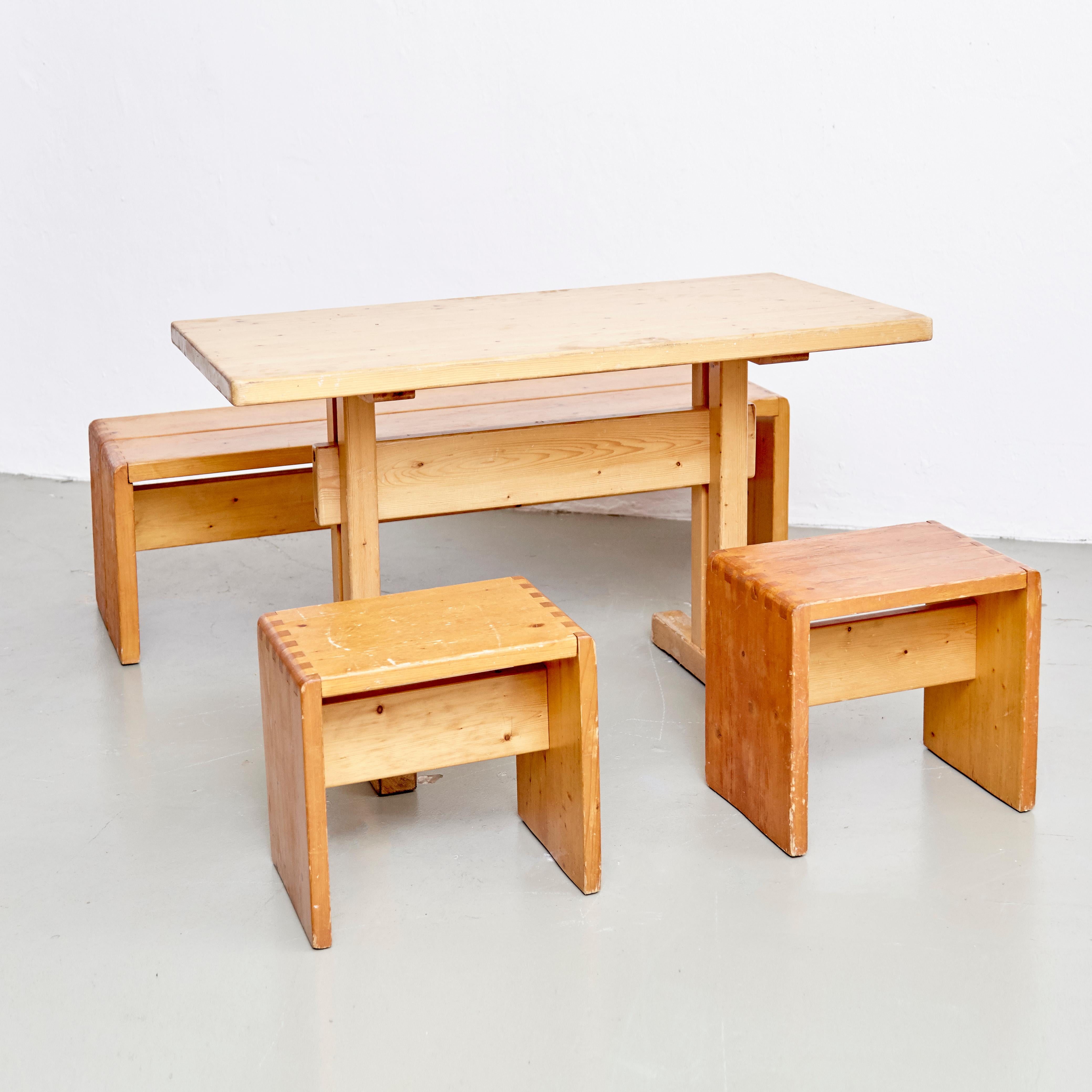 Set of table, stools and bench designed by Charlotte Perriand for Les Arcs ski resort, circa 1960, manufactured in France.

Pinewood.

In original condition, with minor wear consistent with age and use, preserving a beautiful