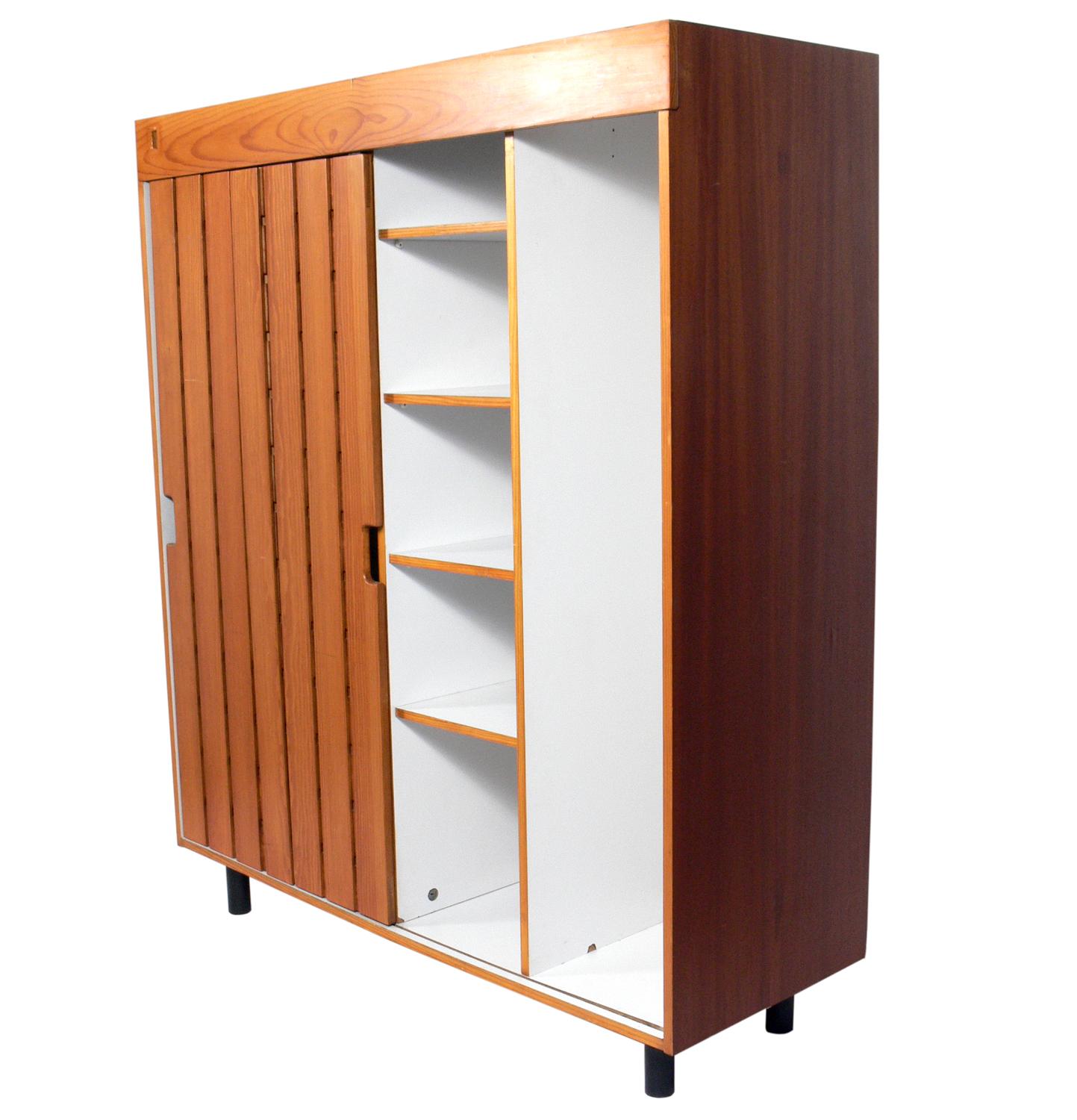Charlotte Perriand wardrobe from Les Arc Ski Lodge, France, circa 1960s. It offers a voluminous amount of storage with the single door sliding to reveal two large compartments on the left and  two large compartments on the right, one with shelves,