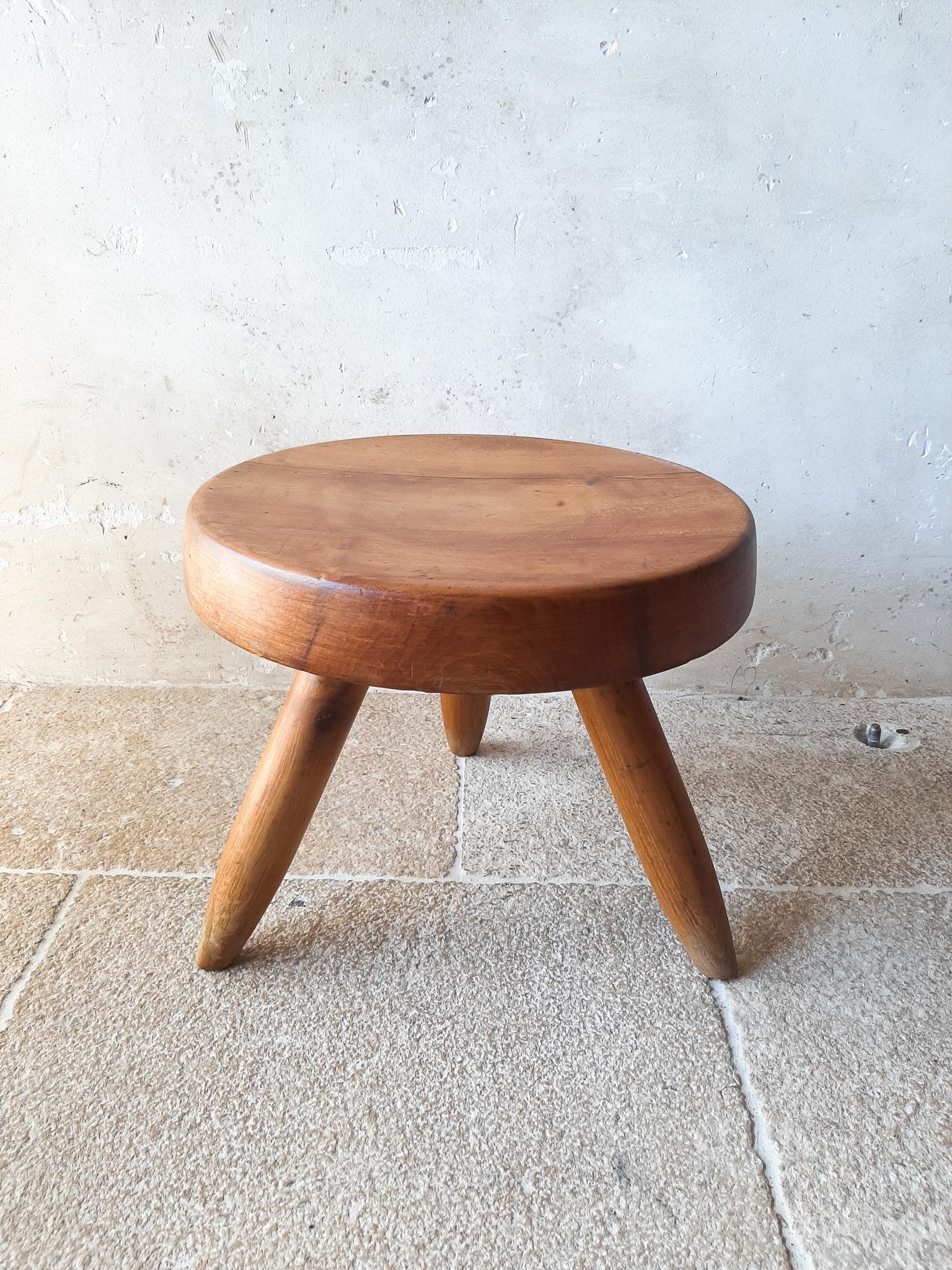 Original Charlotte Perriand, Berger stool for Steph Simon Galleries, circa 1950s. This solid oak wood tabouret tripod, has visible honest aging and patina as you can see on the close-up photo's made in the sun. The typical connection, used for