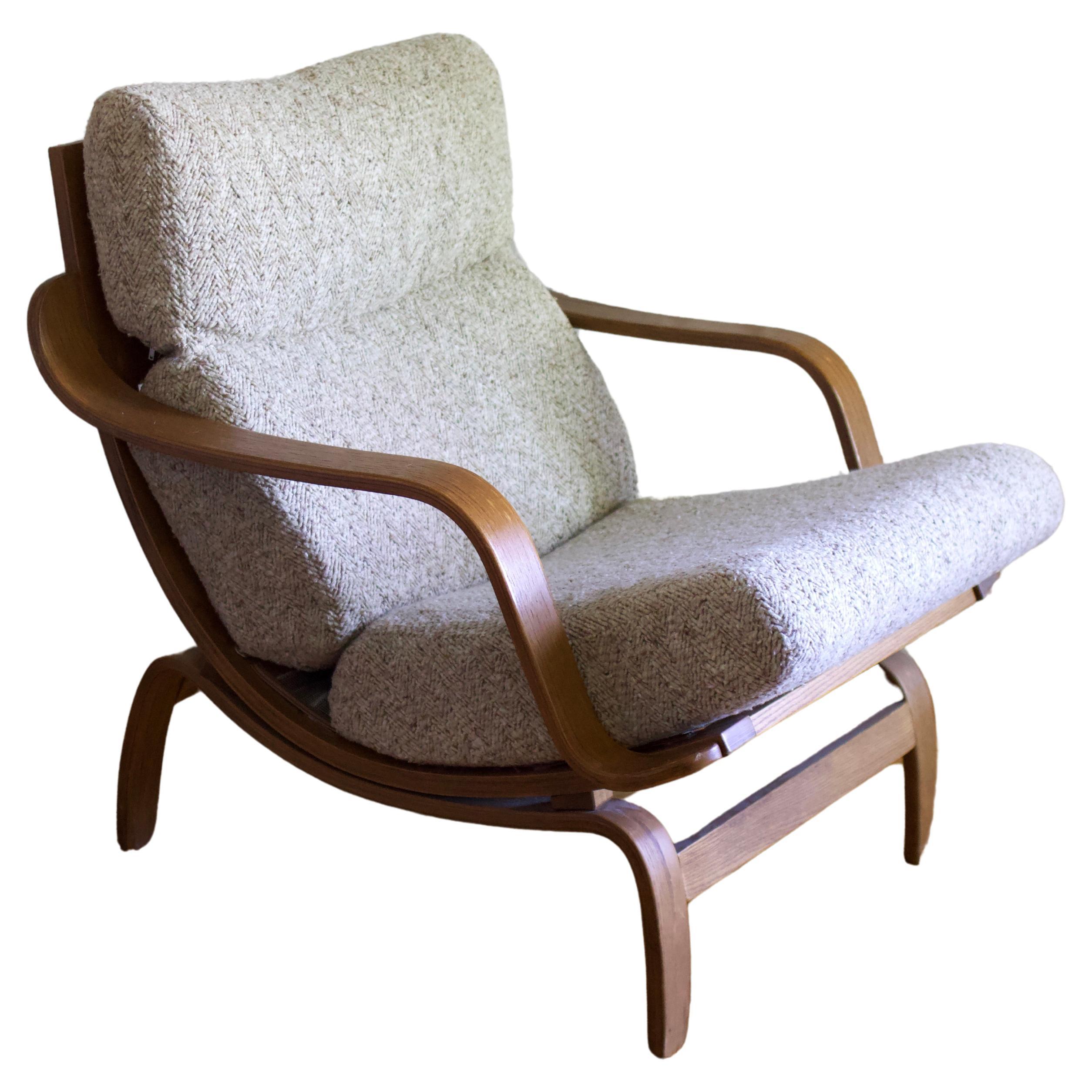 Mid-century modern bentwood Orbit lounge chair and ottoman by Charlton Company (Leominster, MA) for their Century 21 collection. Original woven cream upholstery rests atop curved, warm-toned bentwood. 

Dimensions: 27 1/2