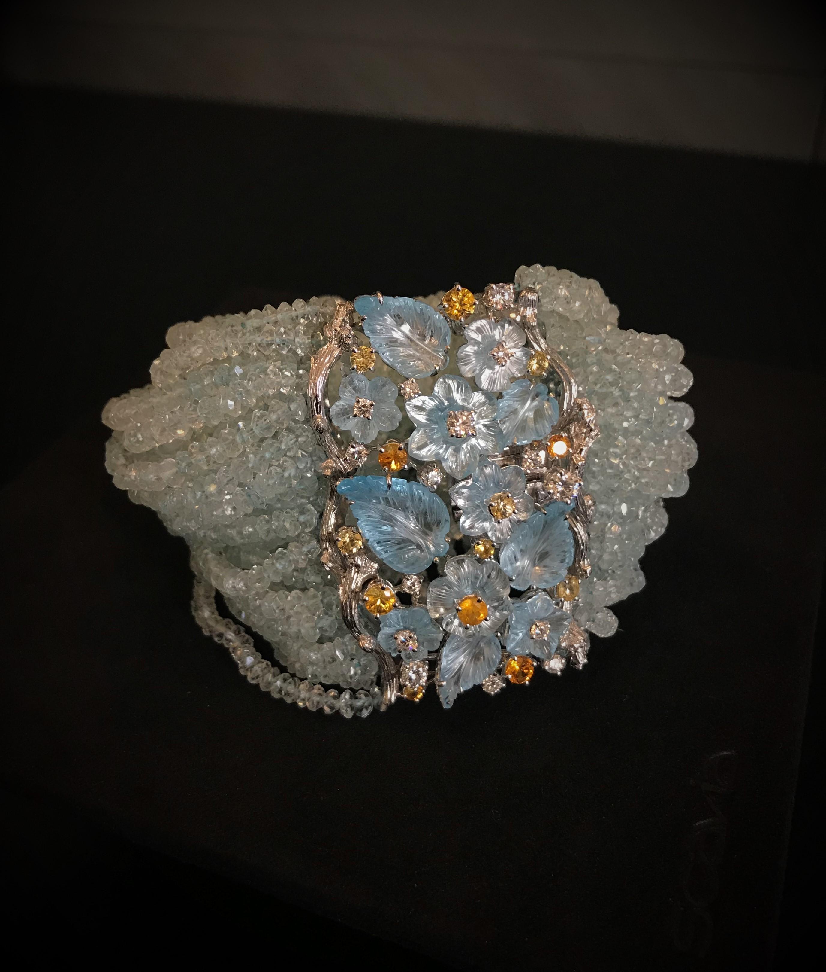 The poetic rhythm of this bracelet composed of carved blue topaz leaves and flowers, aquamarine beads threads, round brilliant cut diamonds, yellow and orange sapphires.
Diamonds: ct. 1.37
Sapphire:  ct. 2.21
Topaz: ct. 39.35
Aquamarine: ct. 629.60
