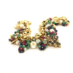 Charm Bracelet in 18 Karat Yellow Gold with Rubies, Emeralds, and Sapphires