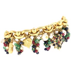 Charm Bracelet in 18 Karat Yellow Gold with Rubies, Emeralds, and Sapphires