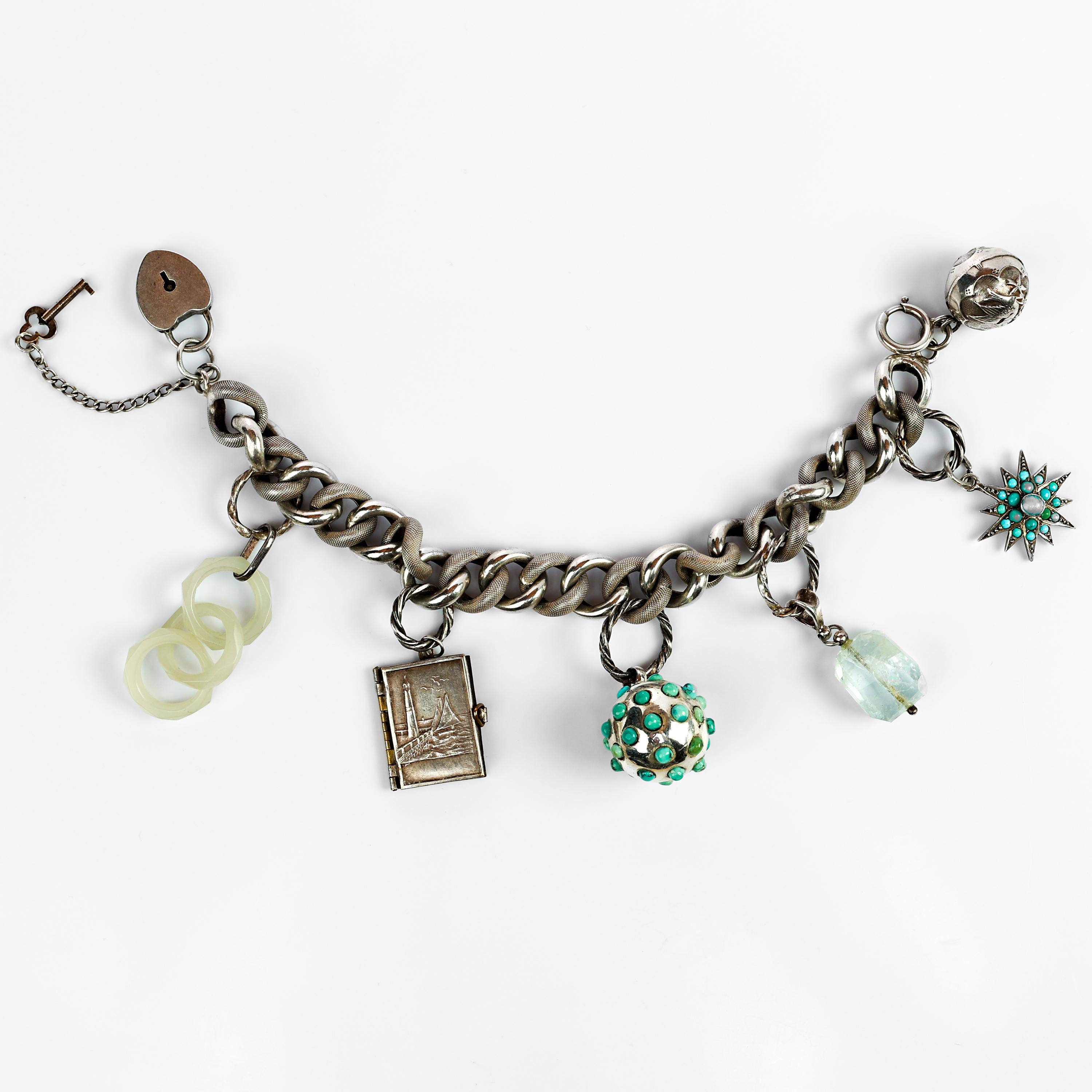 Dating to the late Victorian-era (Circa 1880), this French silver charm bracelet is unusual for both the high-quality of its charms and their uniqueness as well. Charm bracelets are fascinating. In an era when women's voices were so frequently