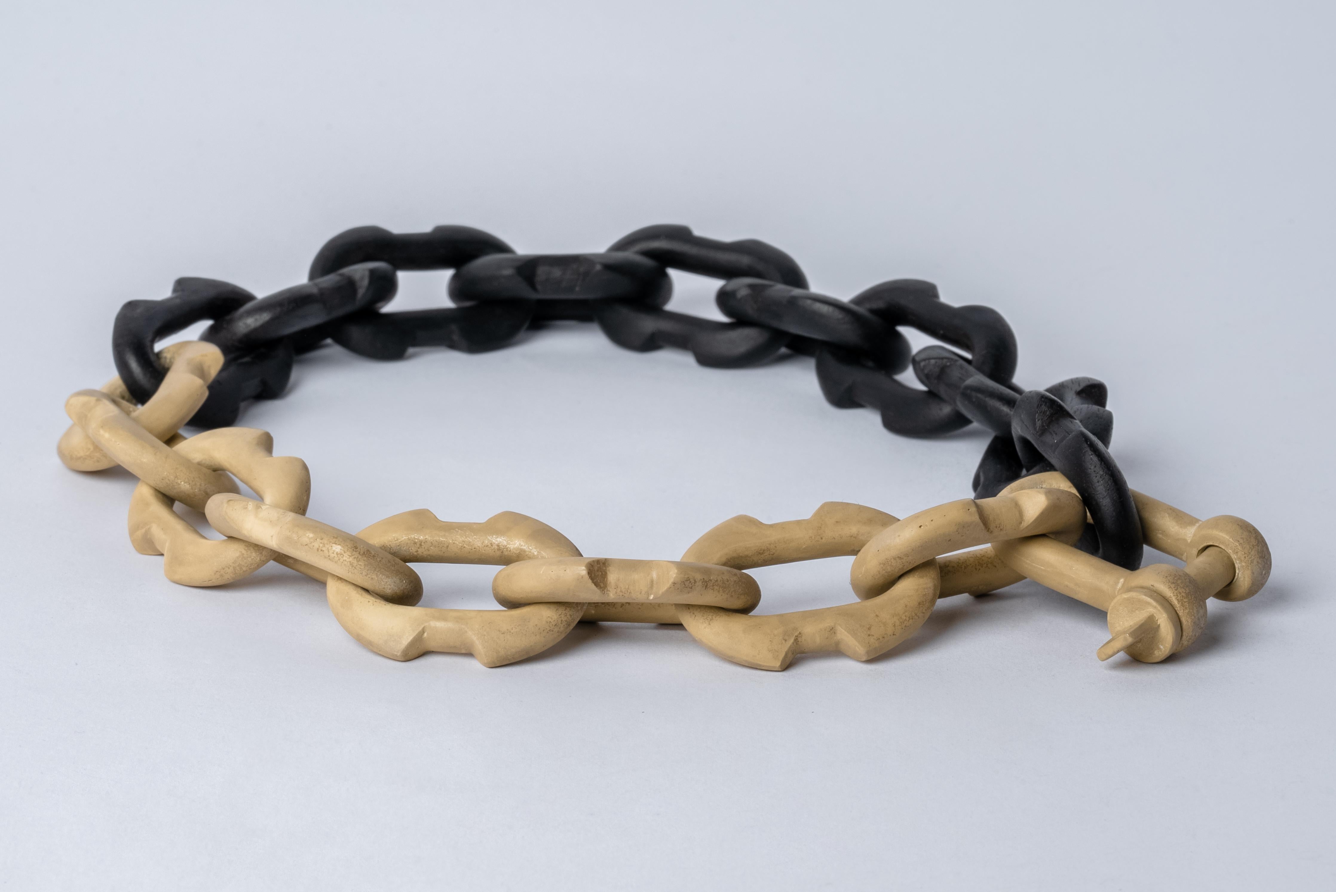 Chain necklace made of brass and wood. All organic chain is carved by hand. In the case of the chains made of wood, they are absolutely seamless; carved from a single long slab of wood (see link). Brass is silver plated and heavy acid treated.
The