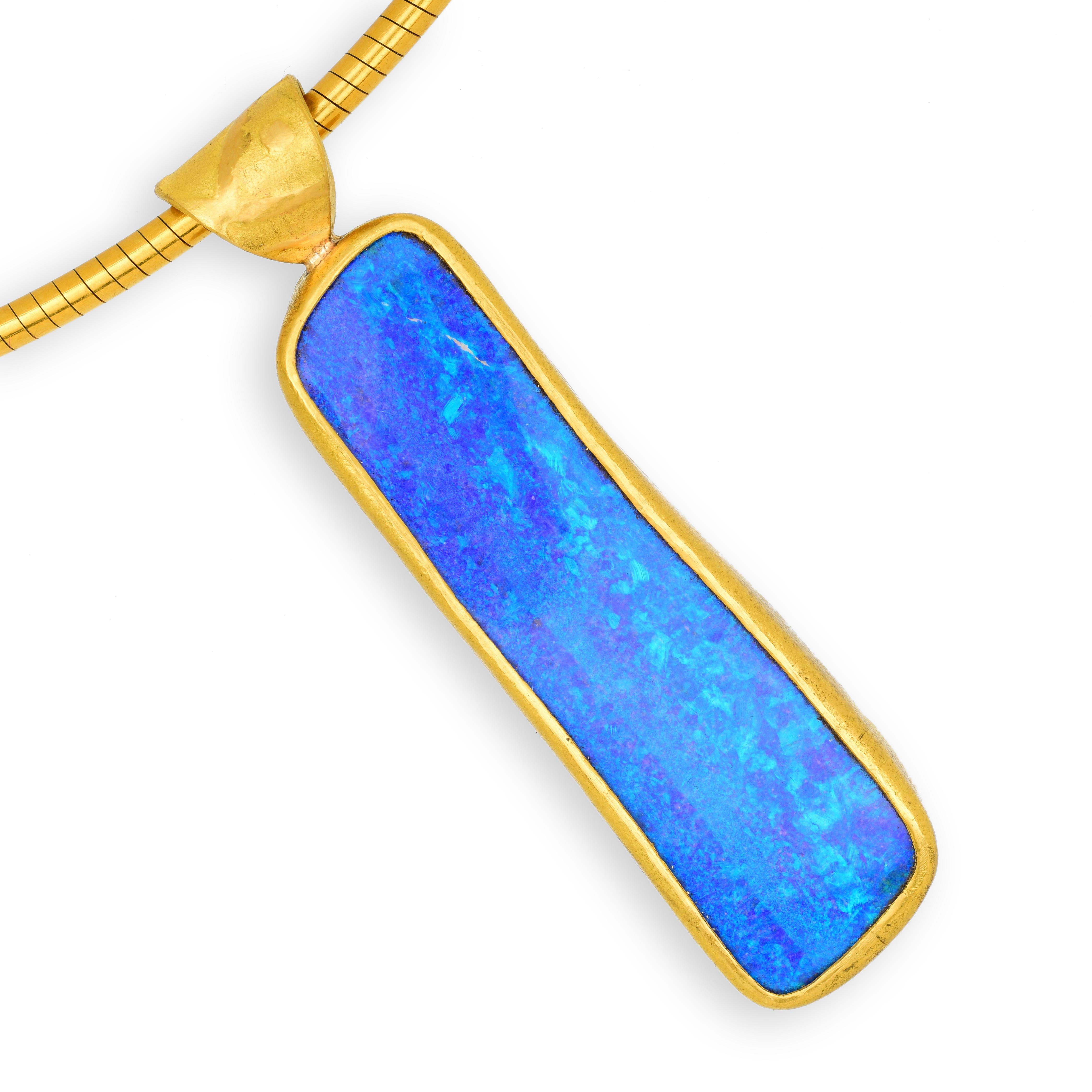 This astonishing solid boulder opal has ultramarine colours that conjure images of the ocean. It is framed with rich and plentiful 22 karat gold. It is a total show-stopper; I cannot over-emphasise the vivid beauty of this piece.

Chain is 42cm and