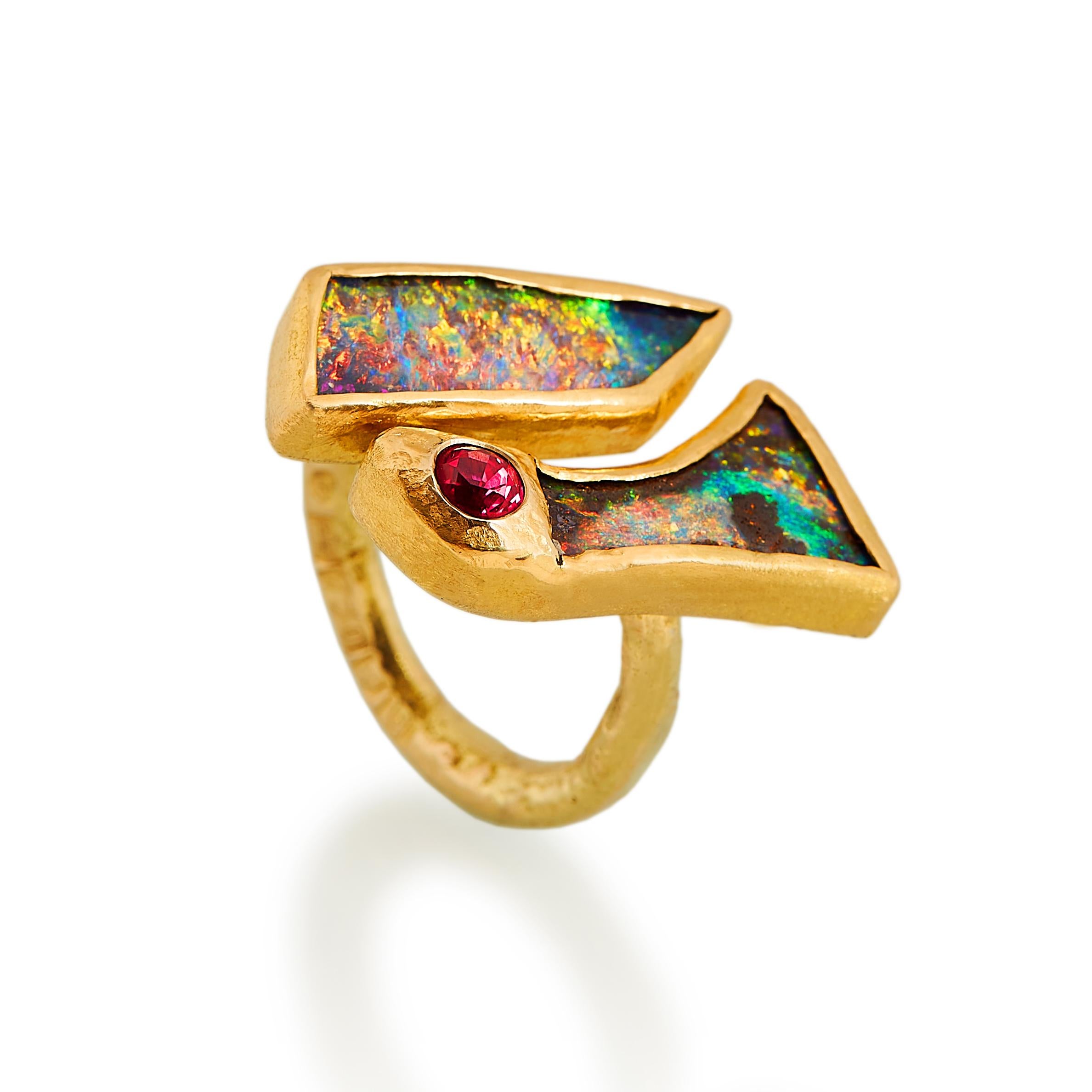This beautiful handmade double boulder opal ring is multicoloured and full of light. The small bright burgundy spinel enhances some of gorgeous red colours in the other stones. Set in rich, textured 22 karat gold, the opals sit on a robust band of