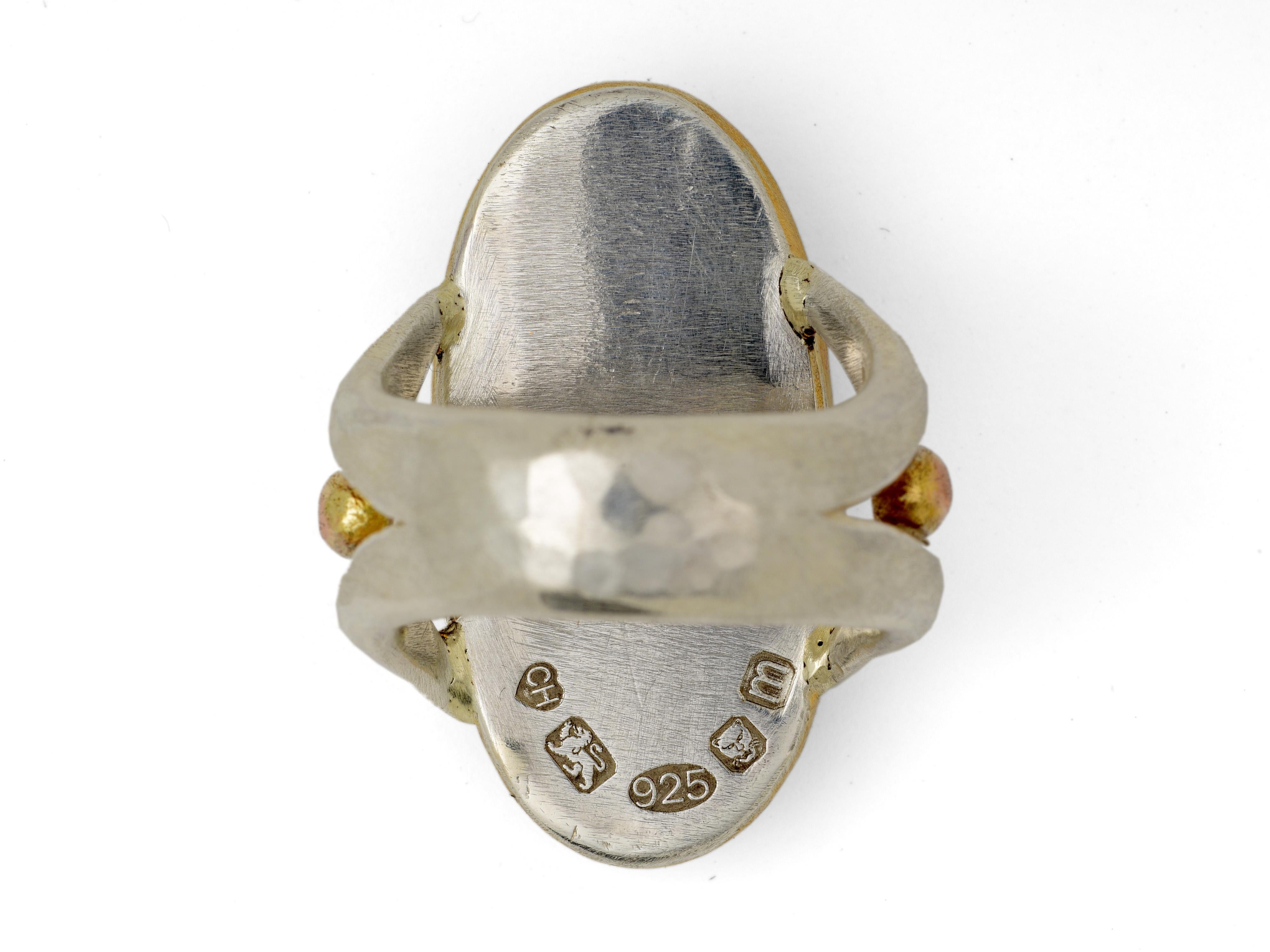 Outstanding Charmian Harris cocktail ring with a large labradorite stone set in 22 karat gold. This mysterious stone is gifted with electric blue flashes. The main shape of the ring is handmade out of sterling silver with grains of rose gold.

U.K