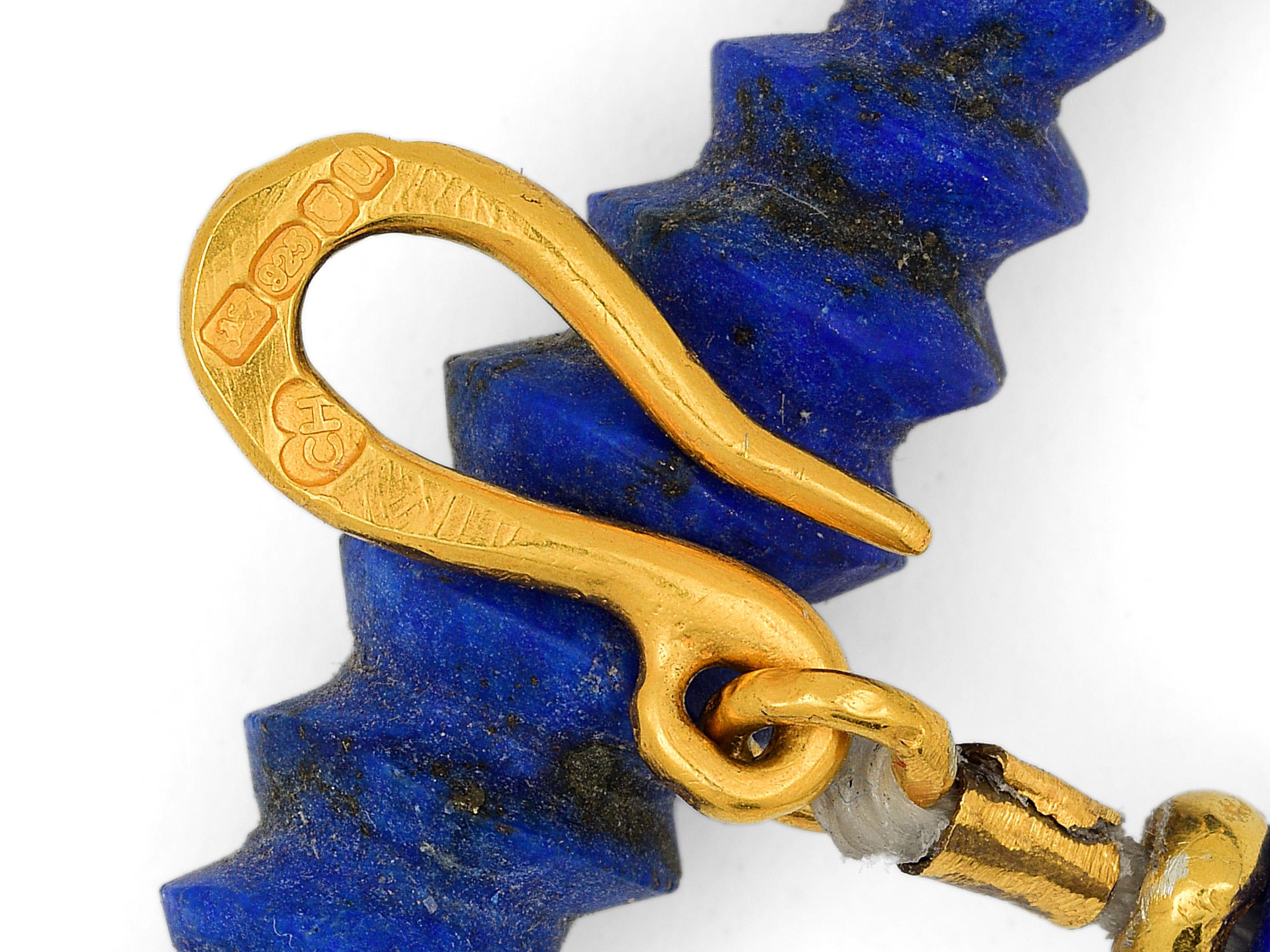 Ancient looking handcrafted lapis lazuli necklace with gold vermeil beads. The lapis beads are a vibrant blue, three of which are very special with hand-carved detail. Most of the metal beads have been made by hand as well as the s-clasp which is