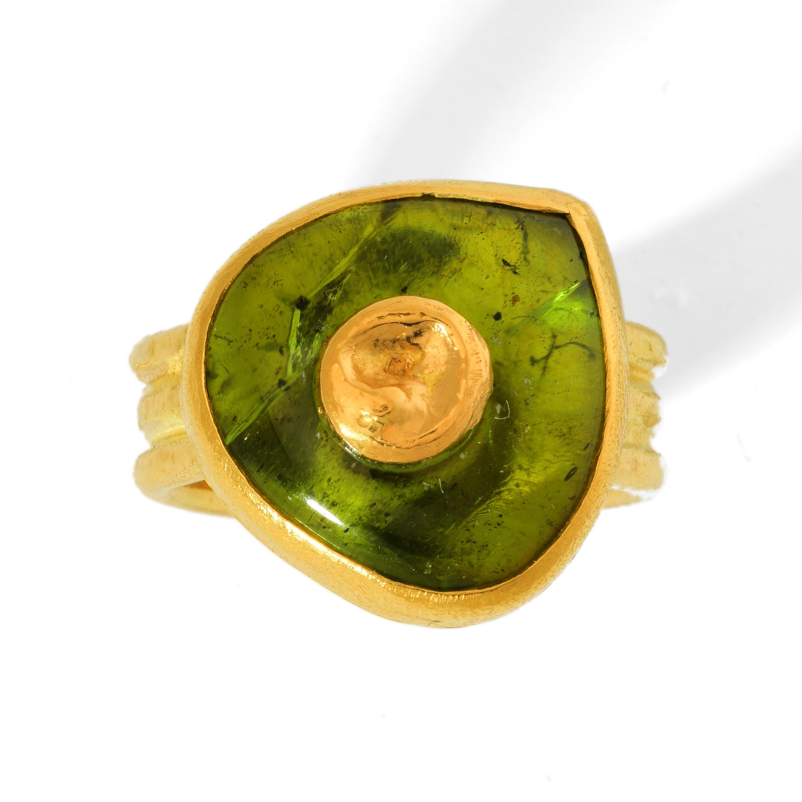 Bold Charmian Harris ring in ample 22 and 18 karat yellow gold with an unusually cut vivid green peridot. Handmade with an organic softness that makes it easy to wear.

U.S size: 7
U.K size: N½

Stone size:
Height: 2cm
Width: 1.8cm
Depth: