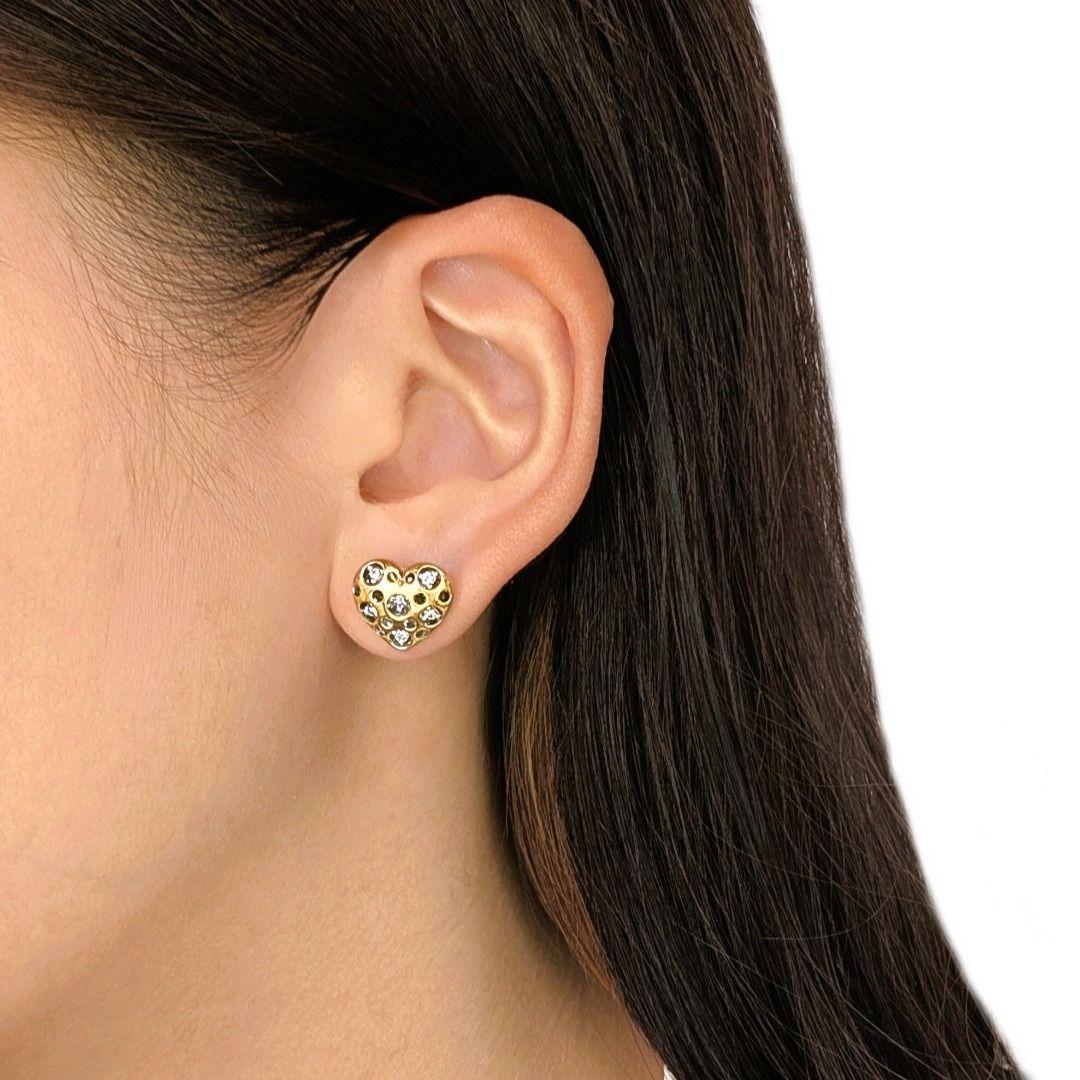 Imagine a sweet sparkle gracing your ears, a charming symbol of affection crafted in beautiful two-toned gold. These 14K two-toned gold heart-shaped stud earrings feature 12 brilliant round diamonds, totaling 0.18ct, with a desirable G color and VS