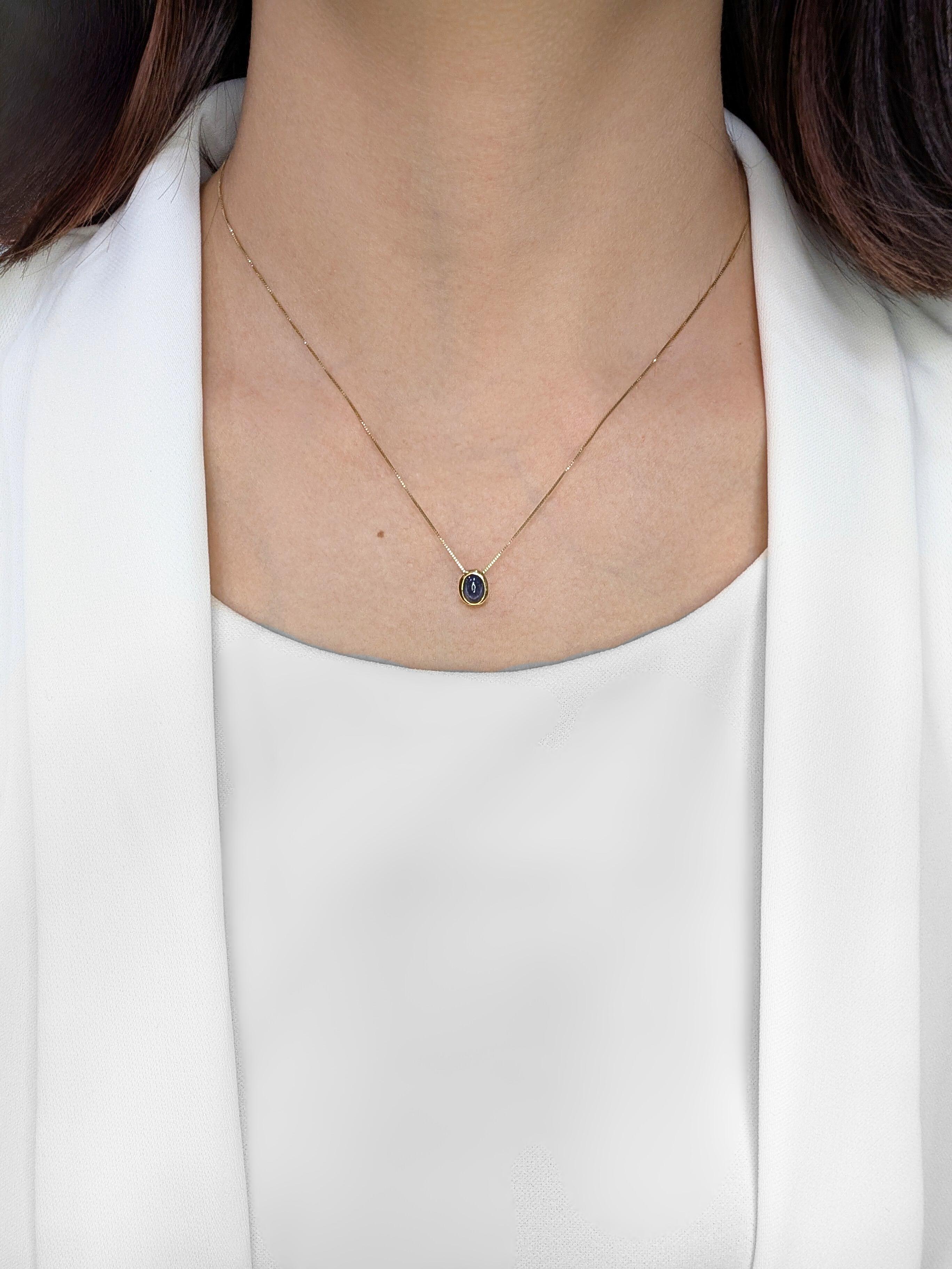 Introducing a captivating new pendant that exudes a warm and sophisticated charm. A stunning 0.8-carat natural sapphire takes center stage, showcasing a smooth and polished cabochon cut that highlights its rich blue hue. The sapphire is securely