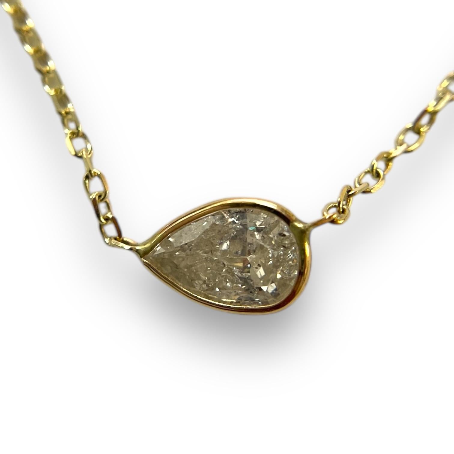 Cette charmante pièce est ornée d'un diamant naturel de 0,76 carat taillé en poire et serti dans un cadre raffiné en or jaune 14 carats. Sa beauté discrète et sa chaîne réglable en font un must pour les amateurs de bijoux modernes.