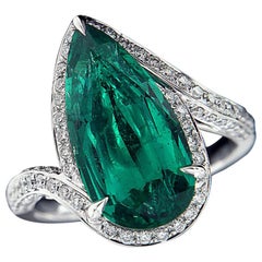 Charming 18 Karat White Gold, Diamond, and Emerald Ring