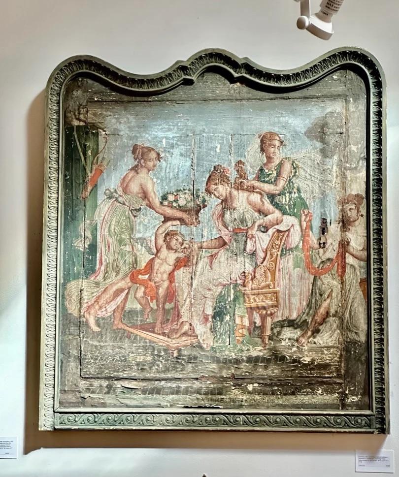Charming 18th century hand-colored wallpaper mounted to a cabinet door, depicting Venus being attended by her servant. 
