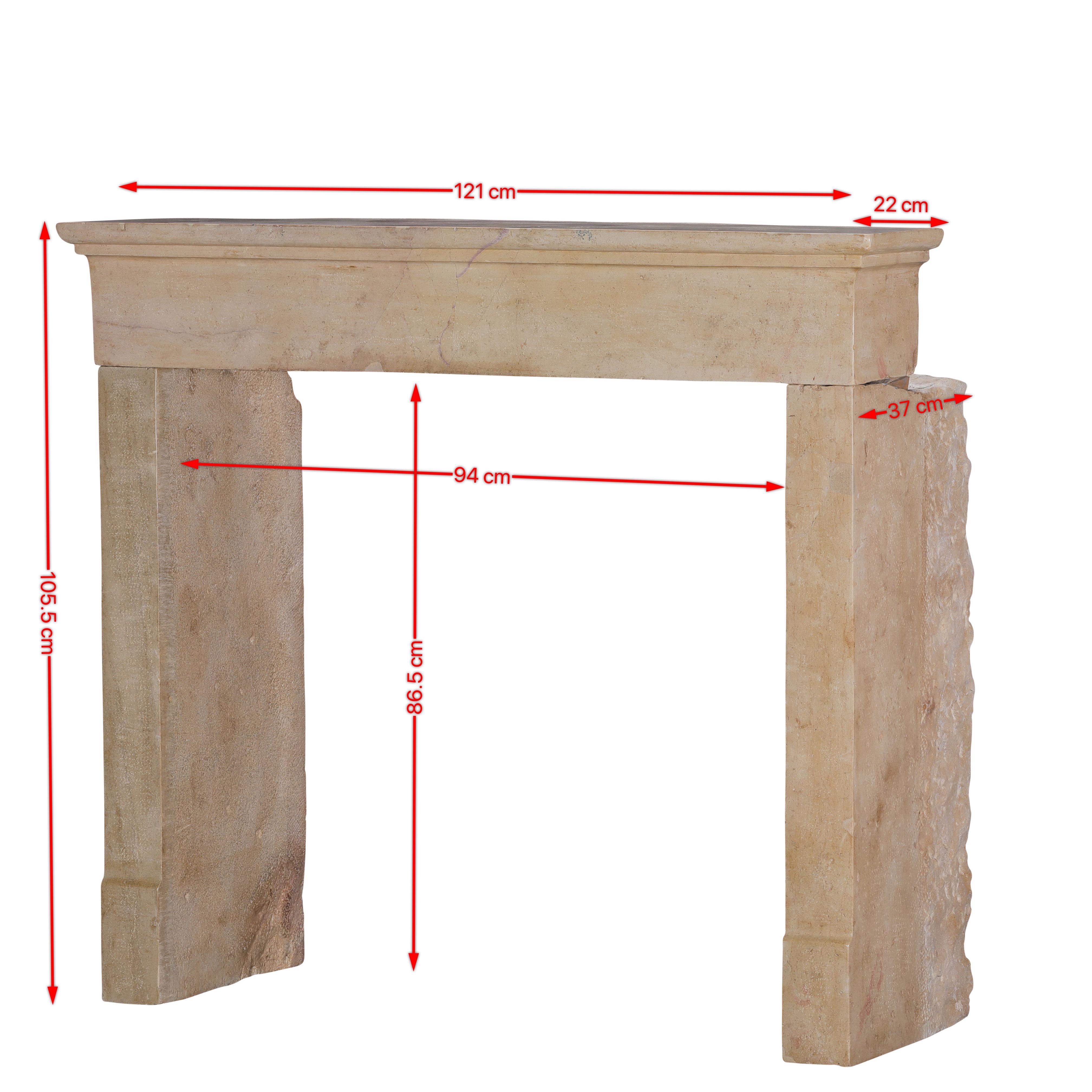 This antique French limestone fireplace surround exemplifies the understated elegance of 19th-century provincial craftsmanship.
Carefully hand-carved from creamy beige hard limestone, it features classic straight lines, a square firebox opening, and