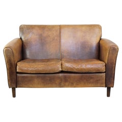 Charming 2-seater designer sofa made of sheep leather with a rustic look