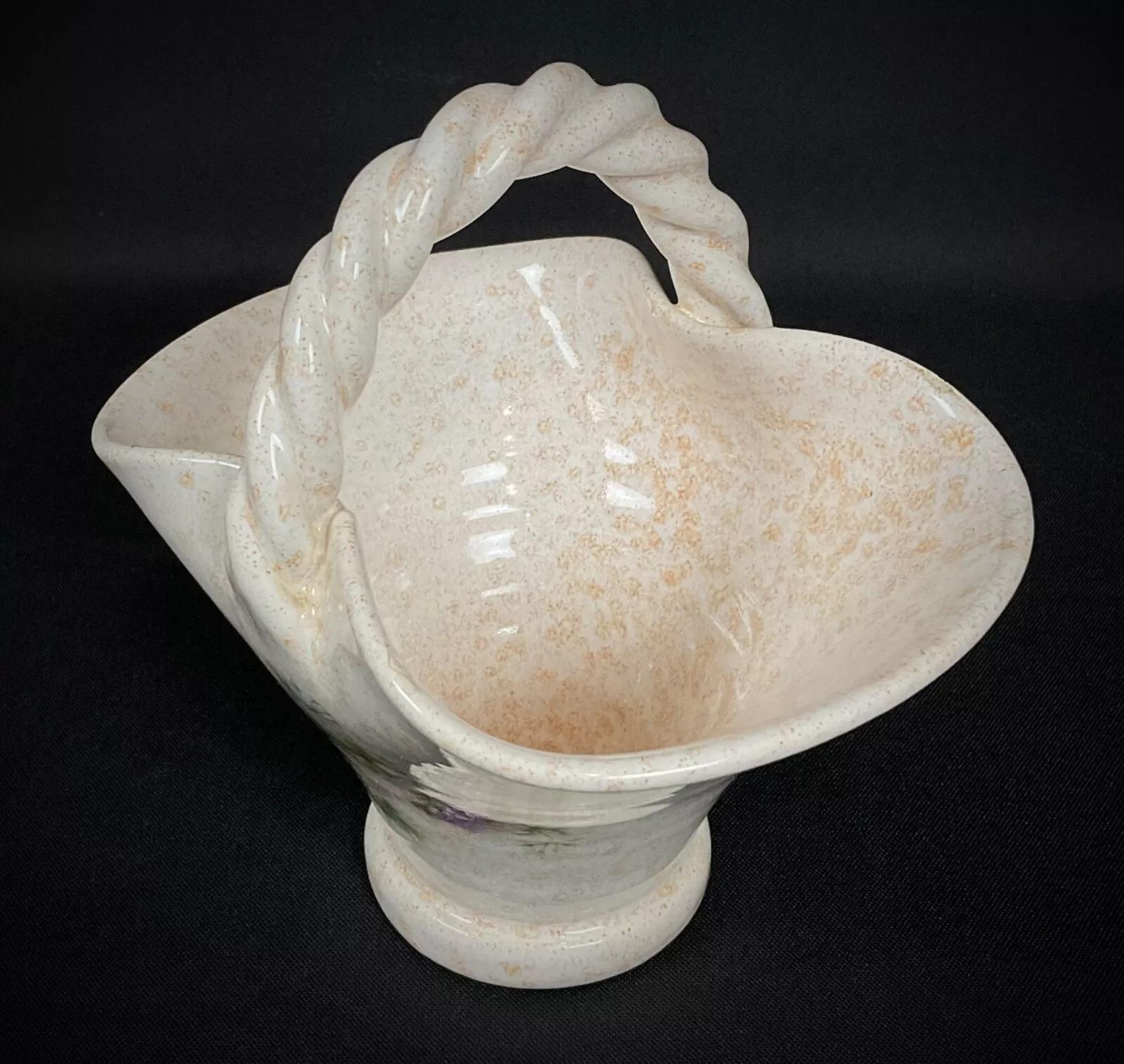This delightful small ceramic basket, signed by Vallauris, features a vibrant floral design, showcasing the elegance of mid-20th century French craftsmanship. Compact and beautifully detailed, it is an excellent decorative piece for collectors and