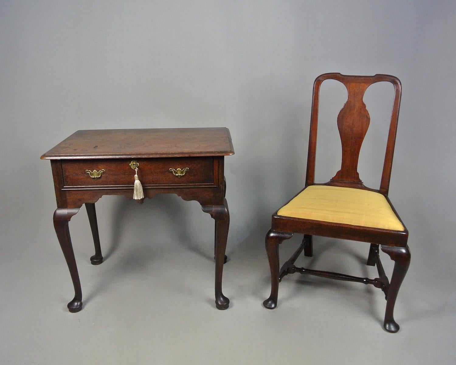 A small, high quality mid 17th century English oak lowboy with an excellent colour and in superior original condition with original brasses and original iron lock with working key. The drawer retaining its original linings. 
 
The twin boarded over