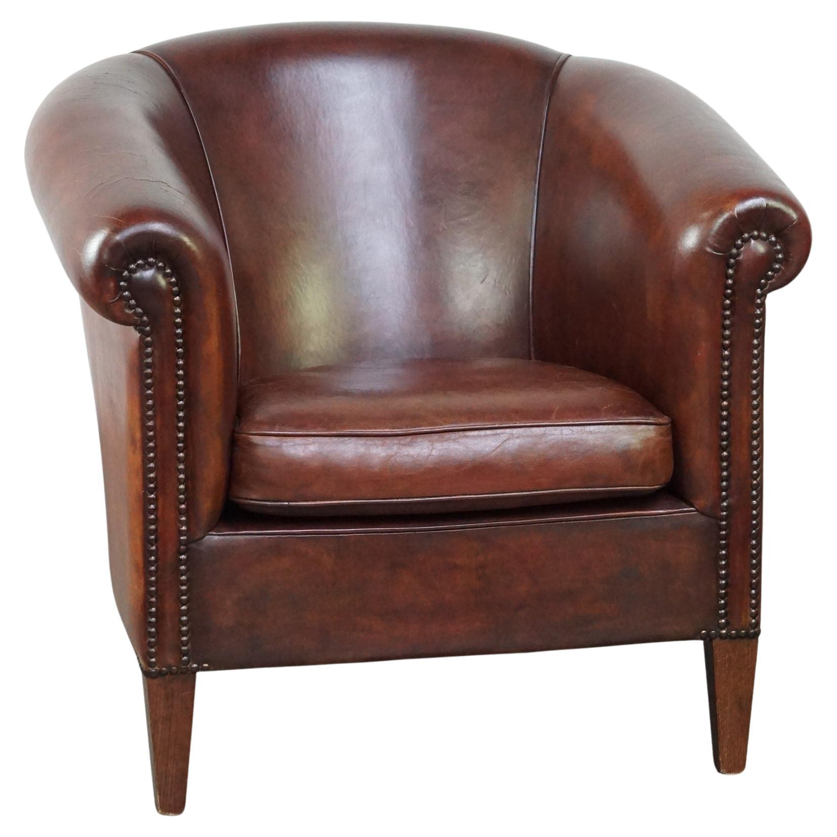 Charming and spacious sheepskin leather club armchair For Sale