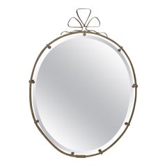Charming and whimsical French brass mirror with ribbon design.