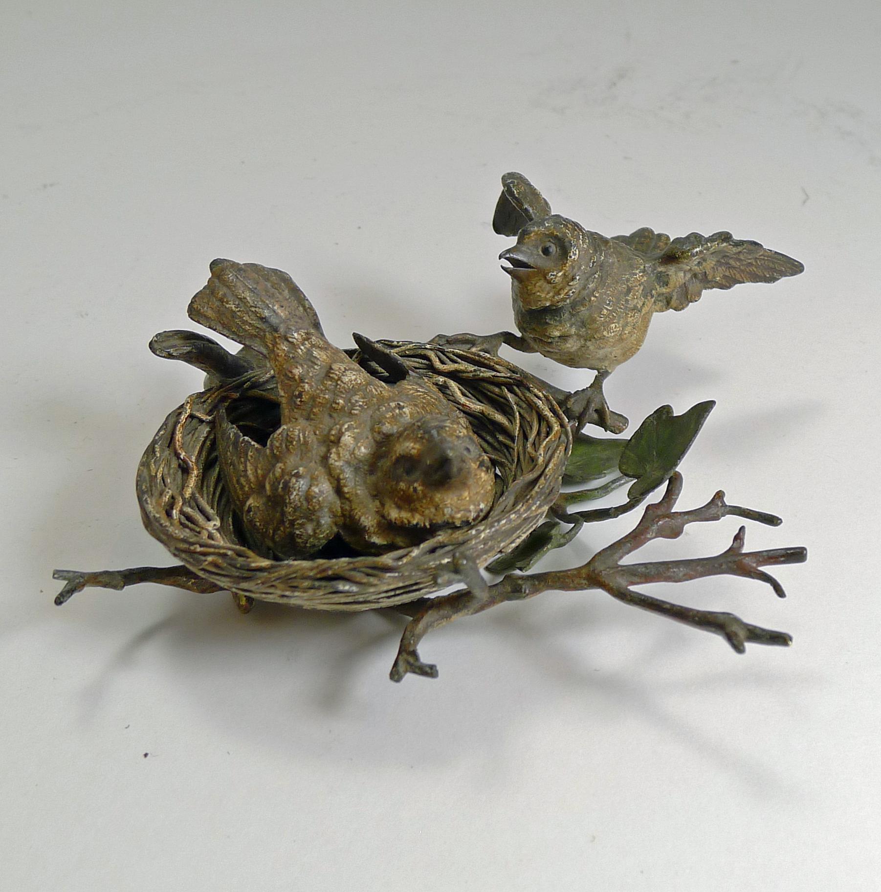 A truly charming cold-painted Vienna figural bronze.

The naturalistic base complete with Ivy leaves, then sits the birds nest with intricate detail and subtle colourings. Inside the nest sits one of the two birds protecting eggs below. The other