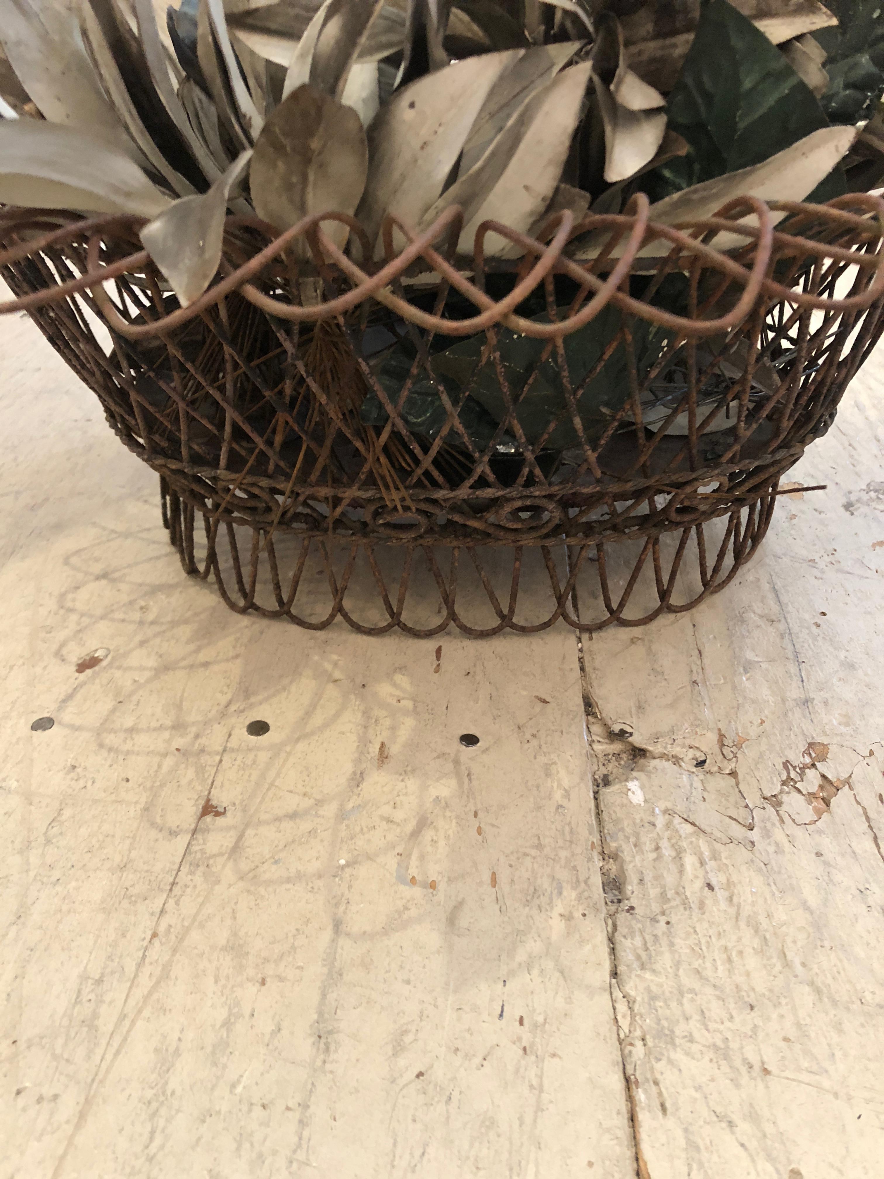 Wonderful tabletop accessory that's a 19th century wire and metal basket planter, filled with tole leaves in a gunmetal grey.