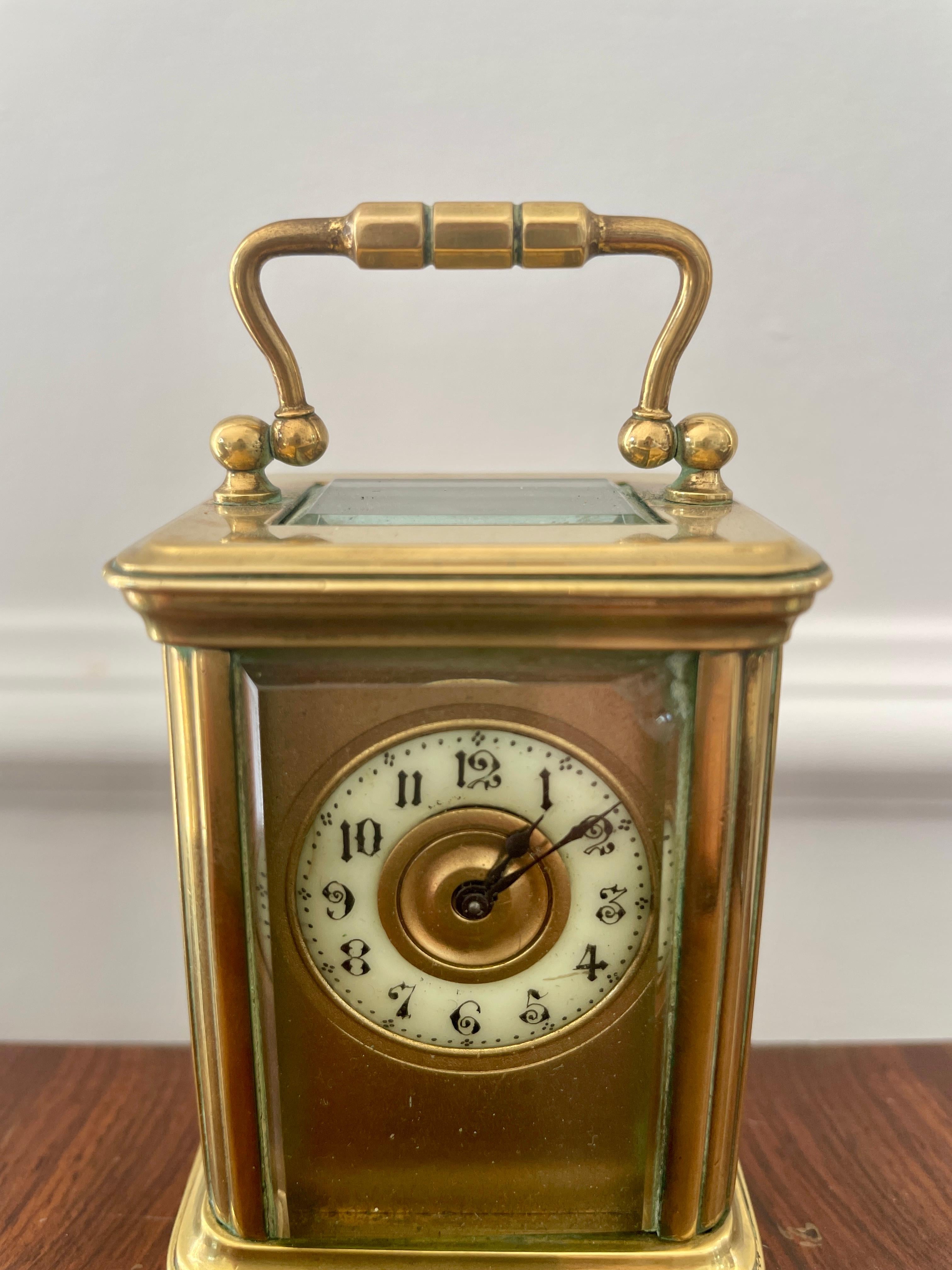 Charming antique miniature lacquered brass cased carriage clock having a pretty enamelled chapter ring and visible platform lever escapement. 

Perfect working order with original key. It has a small chip to the glass (top right) which does not